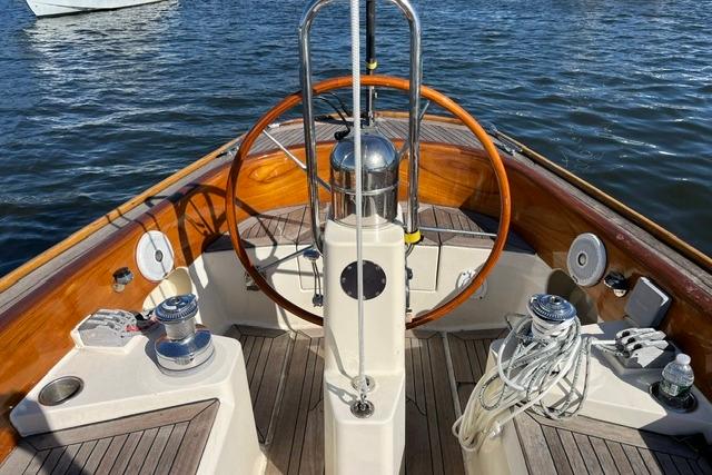 Steering wheel of a 2006 Morris 36 sailboat on calm water.