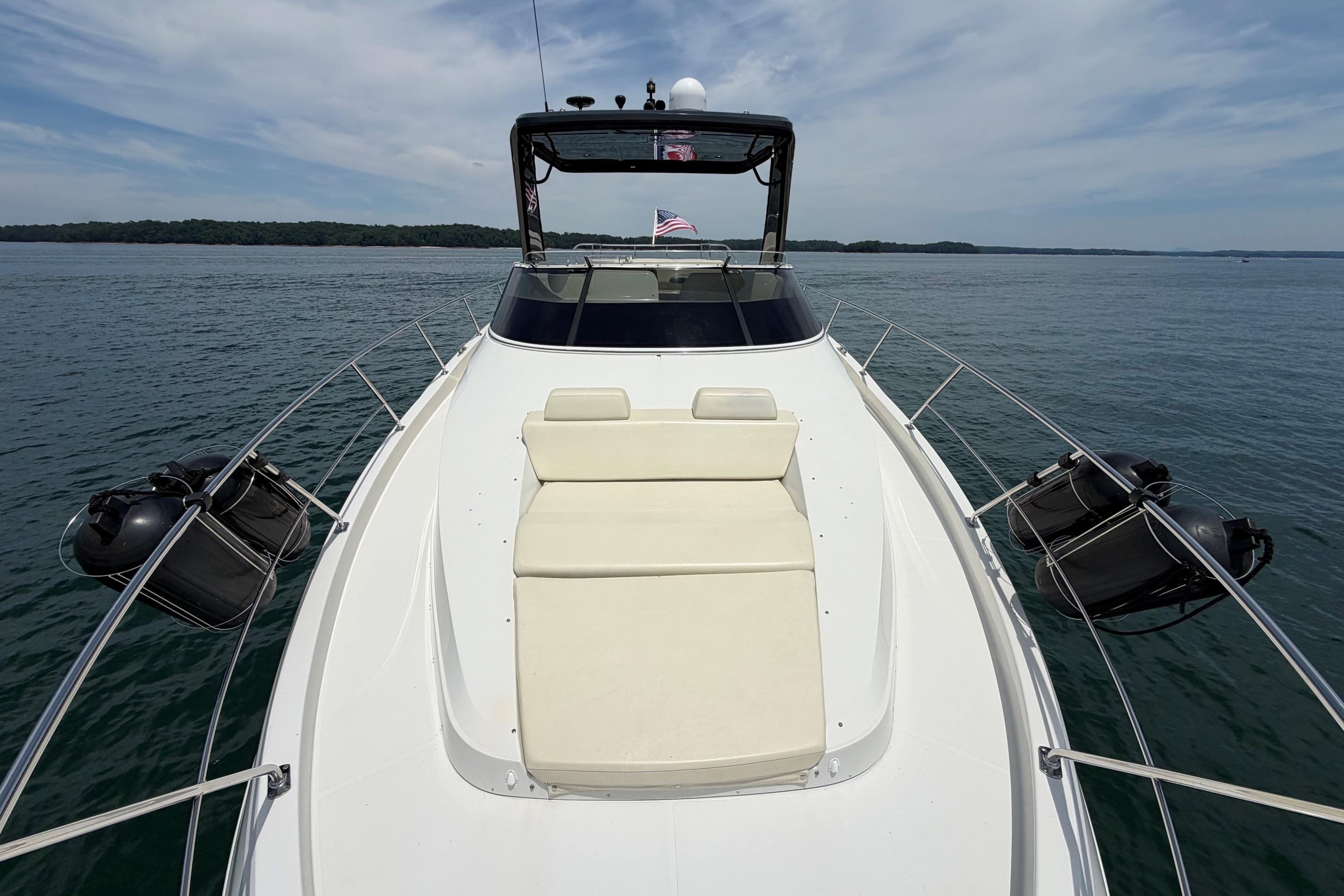 2011 Carver 44 Sojourn yacht on calm water, featuring a spacious deck and seating area.