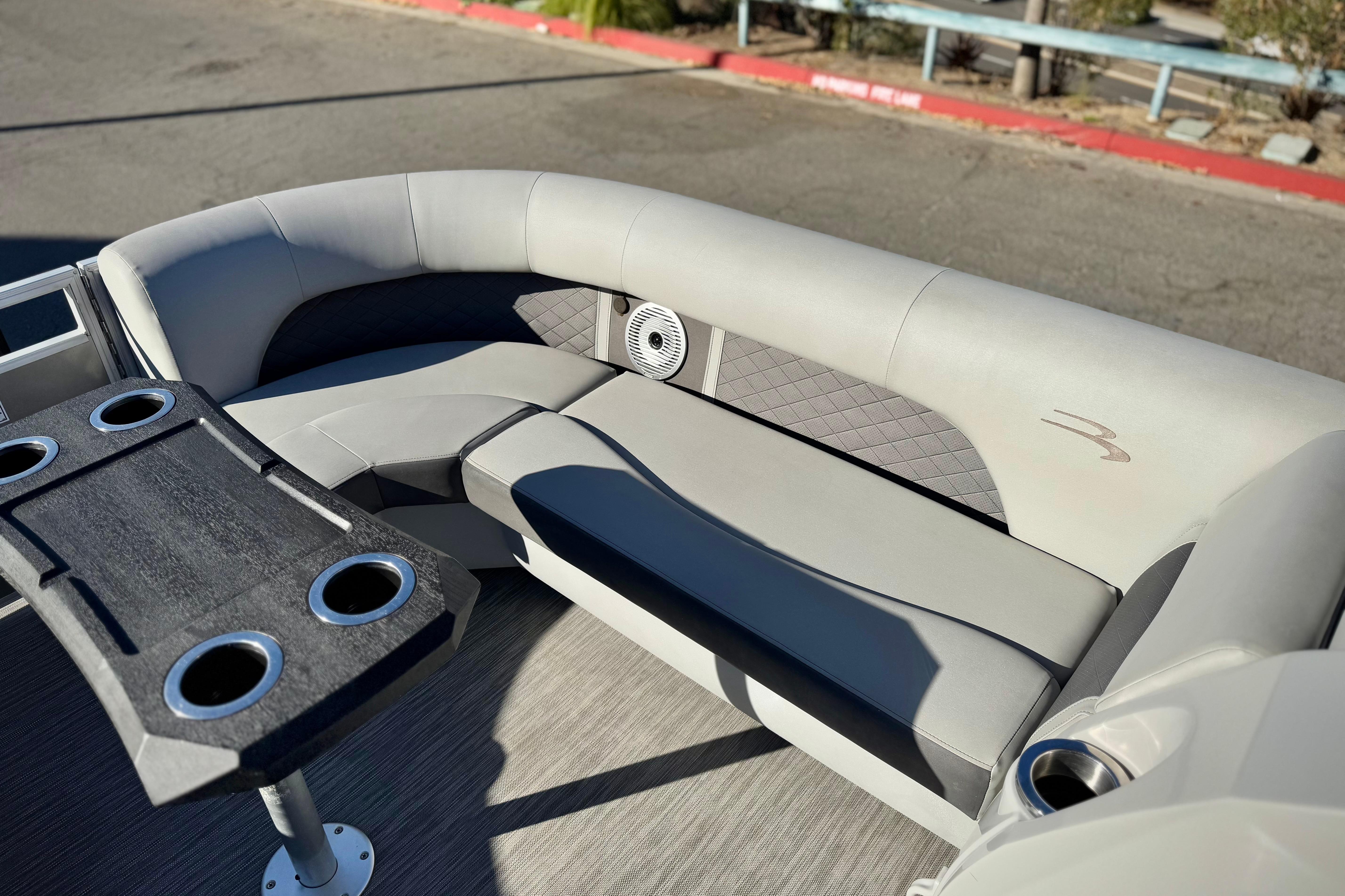 2021 Bennington 23LSR pontoon boat interior with gray seating and cup holders.