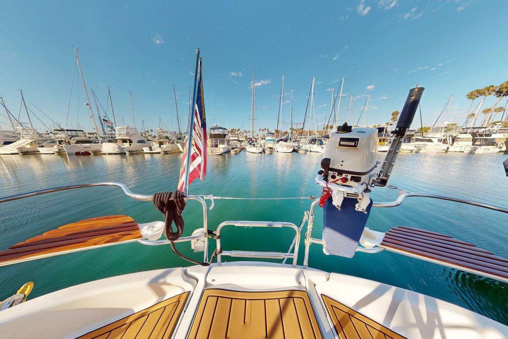Hunter Legend 40.5 sailboat, 1997 model, docked in a sunny marina with clear blue skies.
