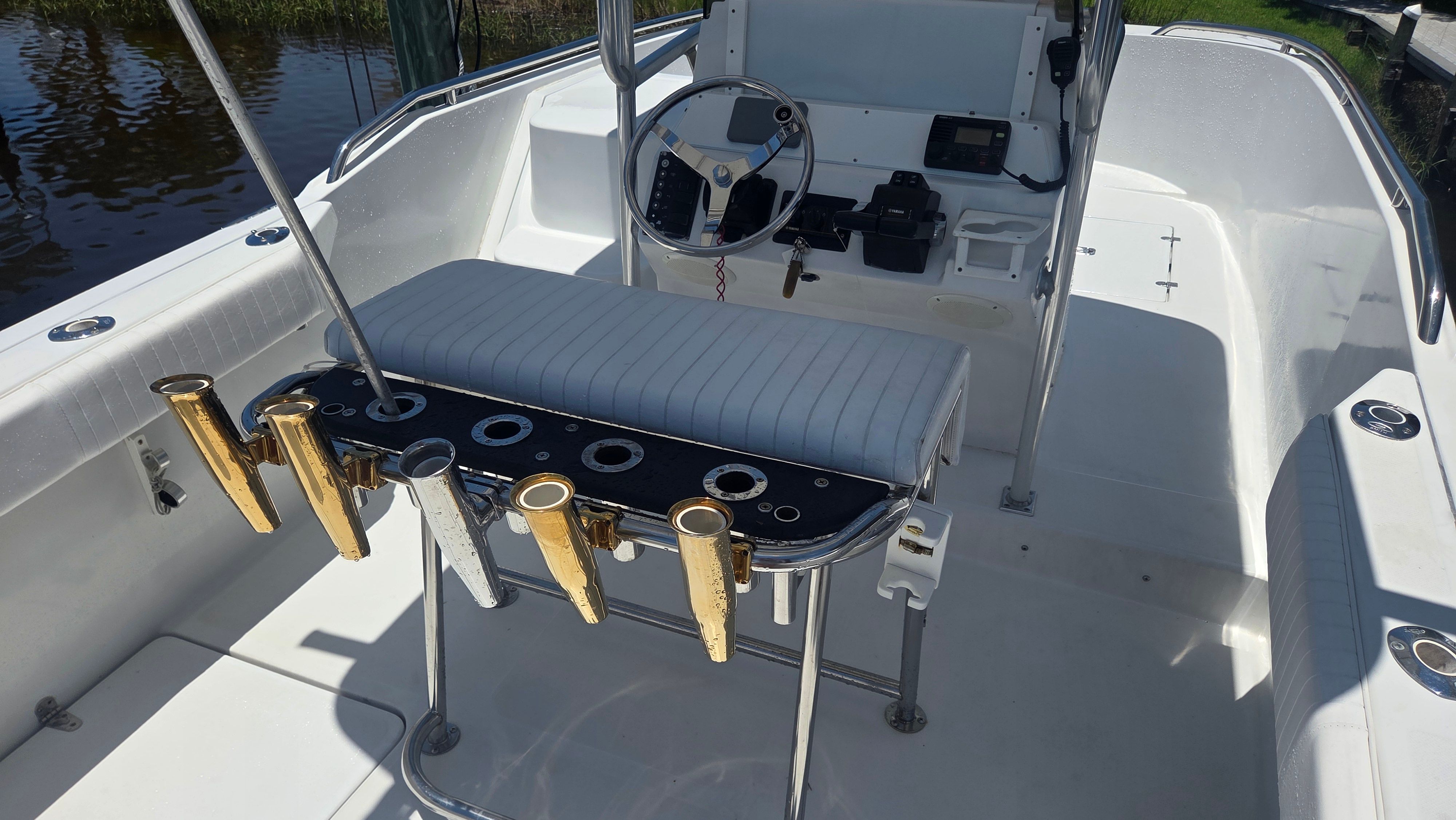 The image shows the cockpit of a 2001 Glacier Bay Canyon Runner 2260 with fishing rod holders.