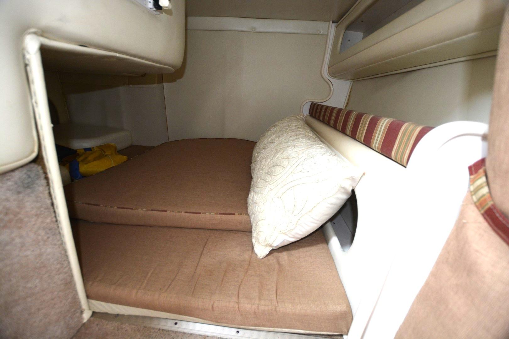 1999 Rinker 270 Fiesta Vee cabin interior with cushions and pillow.