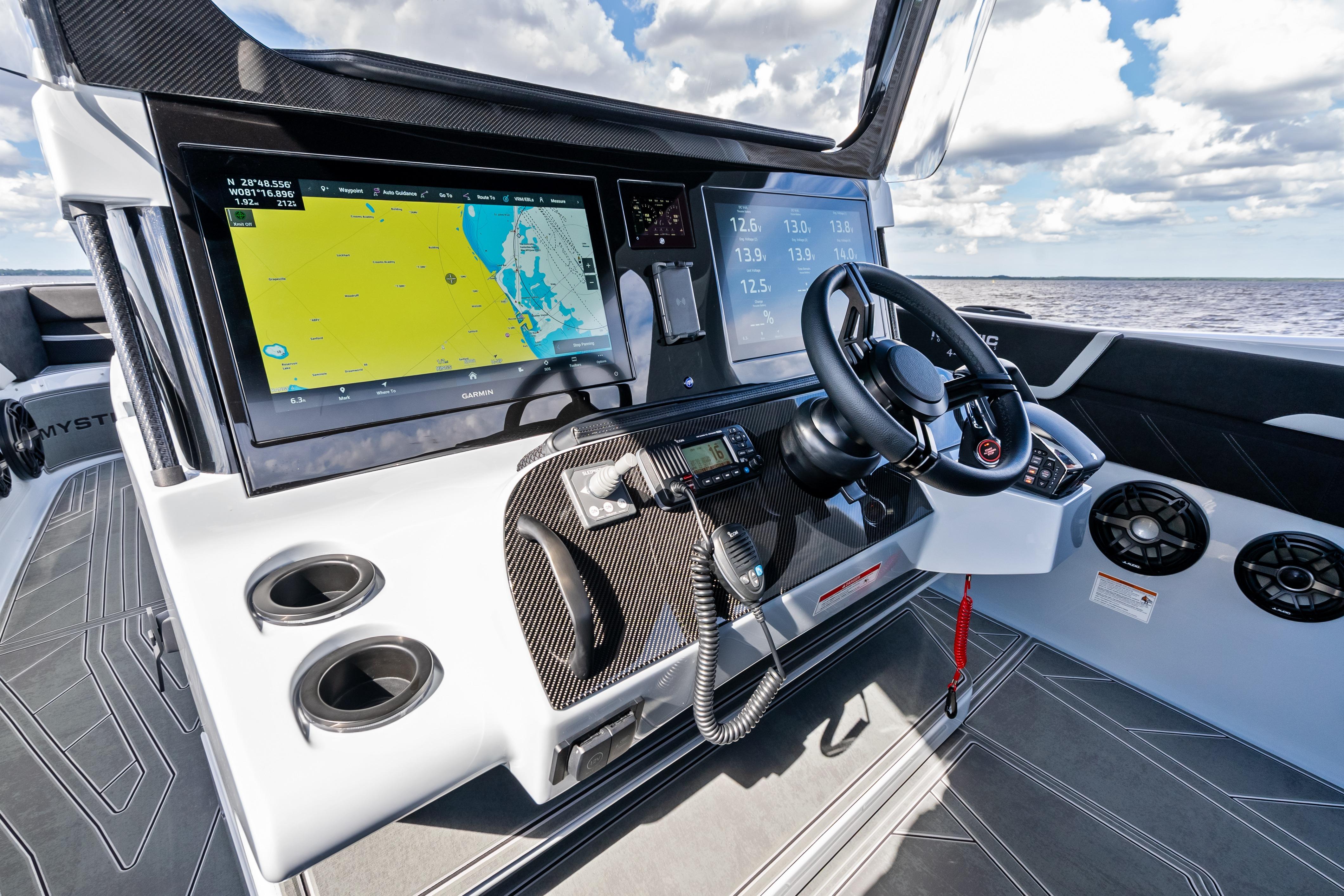 Cockpit of 2027 Mystic Powerboats M4200 with advanced navigation system and sleek design.