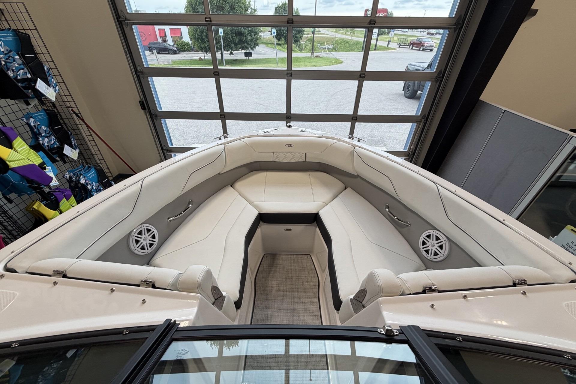 Interior view of 2027 Regal LS2 boat with white seating and speakers.