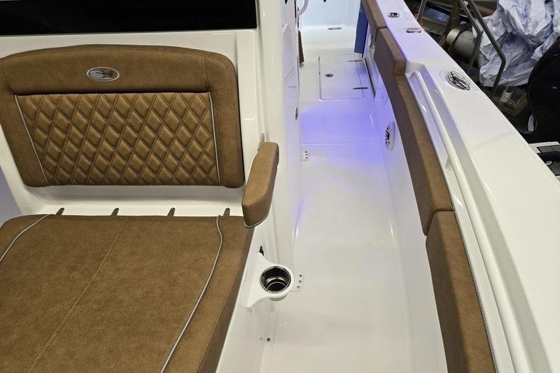 2026 Sea Hunt Ultra 275 Coffin Box interior with brown cushioned seating and sleek design.