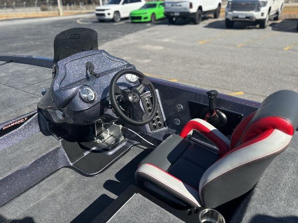Interior of 2025 Phoenix 920 Elite boat with steering wheel and seat.