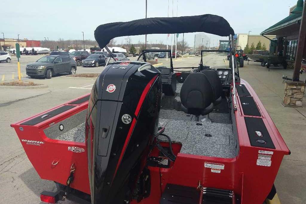 2026 Tracker Targa V-18 WT boat with powerful outboard motor, parked in a lot.