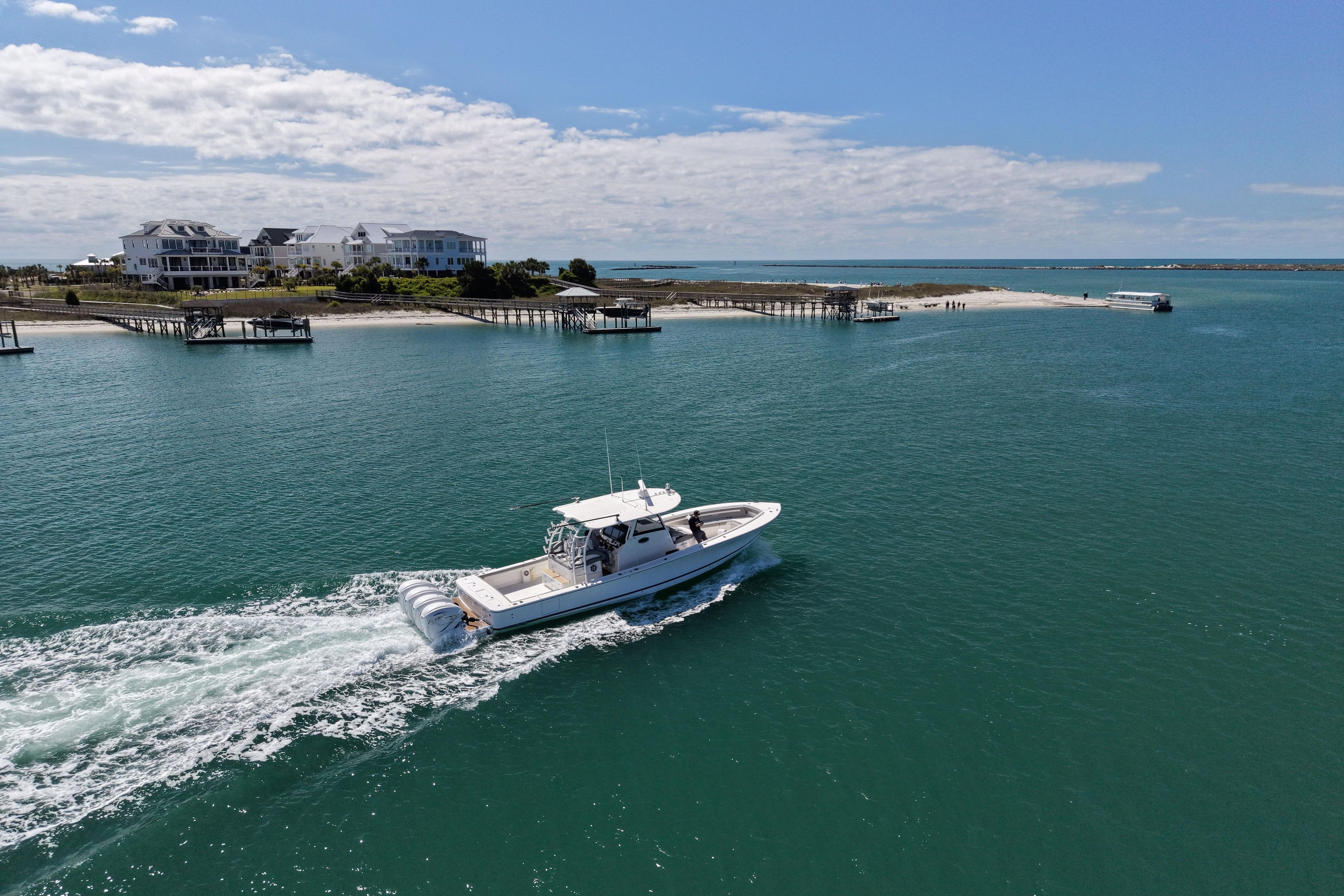 2023 Regulator 41 boat cruising near coastal homes and docks.
