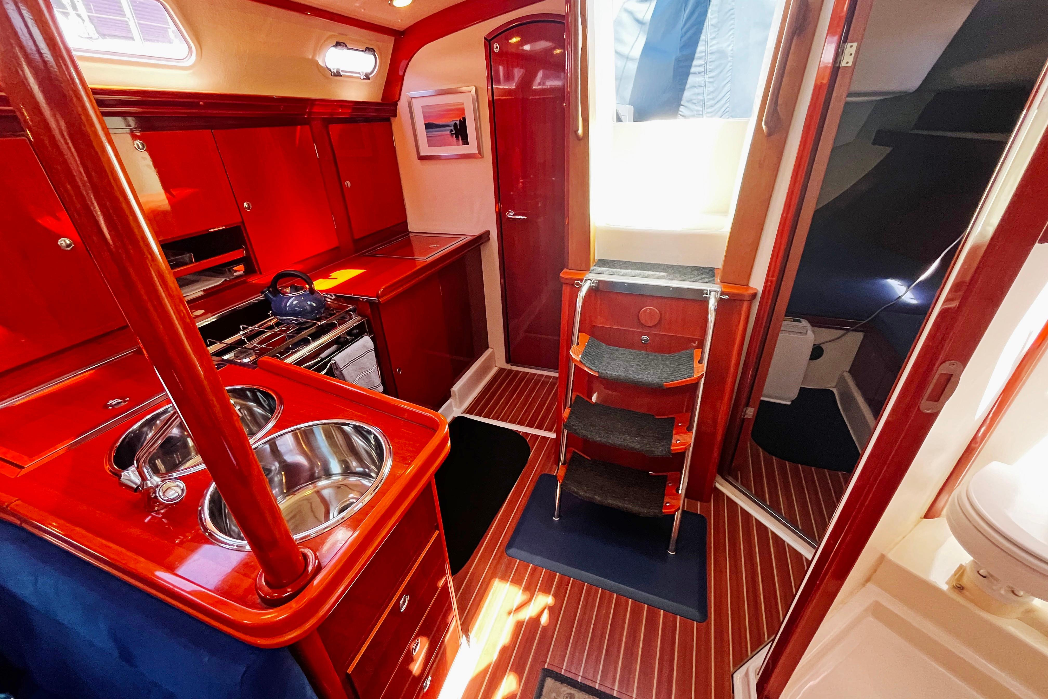 Luxurious 2004 Hanse 411 yacht interior with polished wood finish and modern amenities.