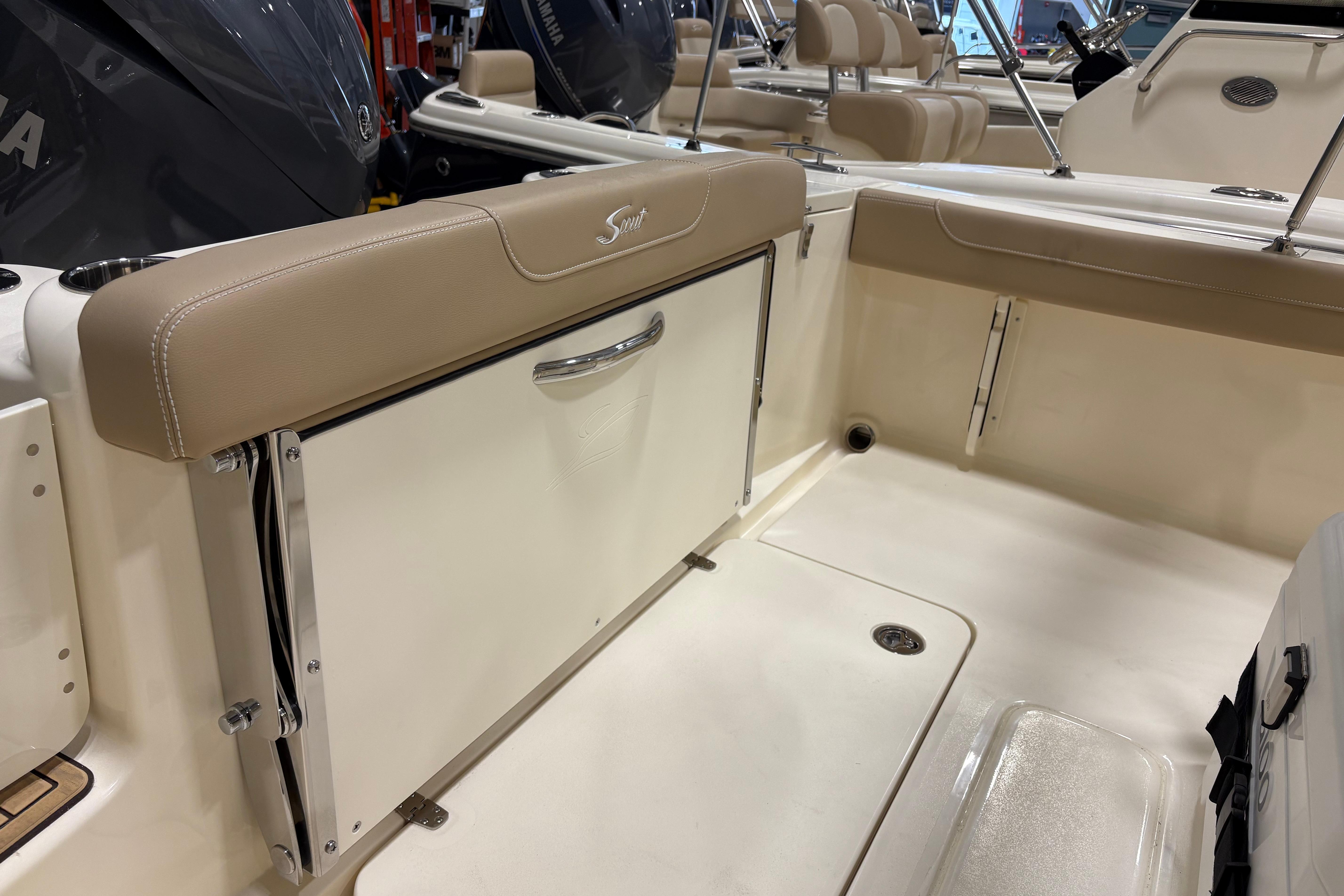 2025 Scout 215 XSF boat interior with beige seating and storage compartment.