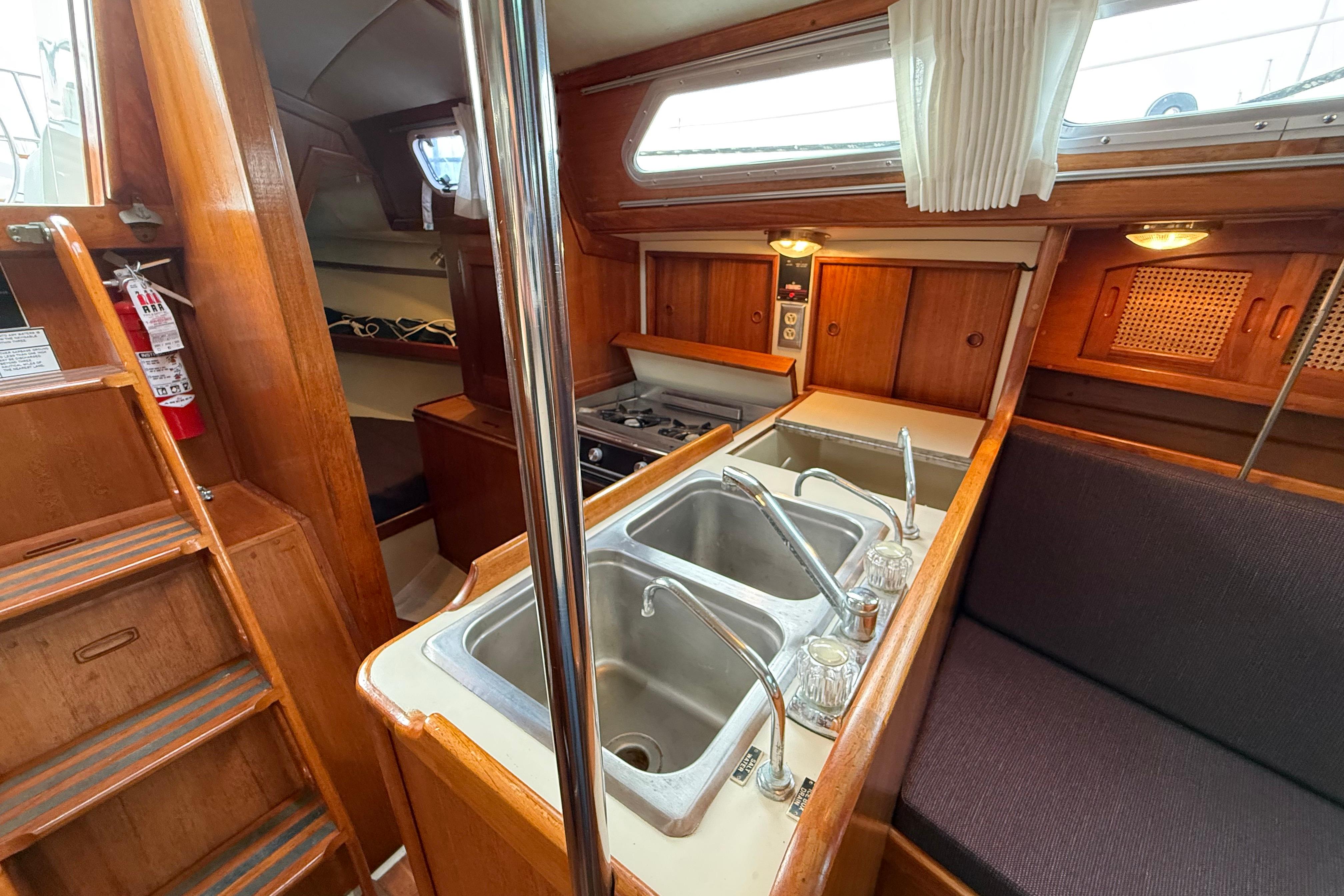 Interior of 1988 Ericson 32-200 sailboat with kitchen and seating area.