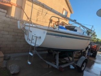 2002 Catalina Capri sailboat on trailer in yard.