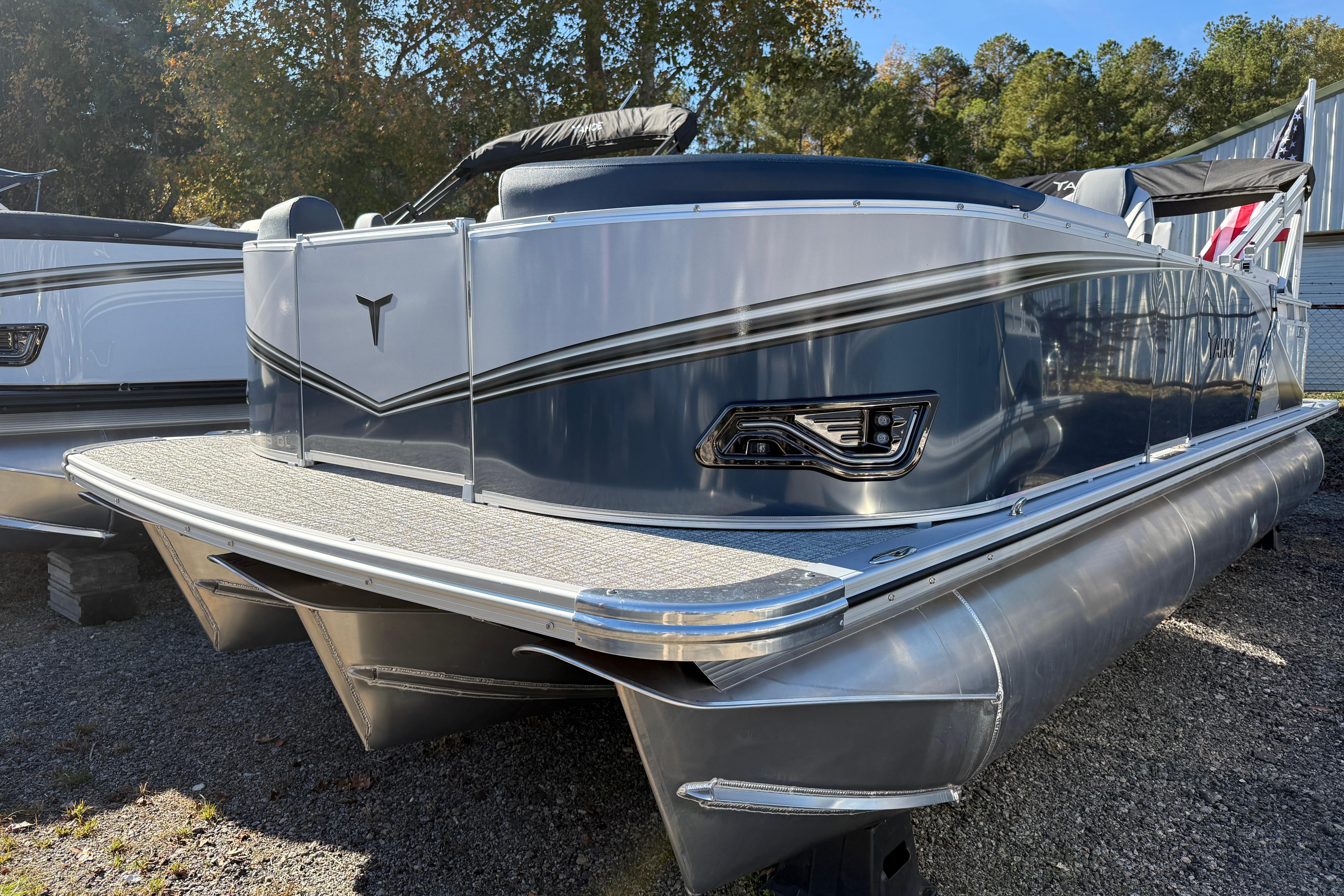 2026 Tahoe Pontoon LTZ Quad Lounger, sleek design, parked outdoors, side view.