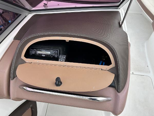 2010 Cobalt 262 boat dashboard with open glove compartment and stereo system.