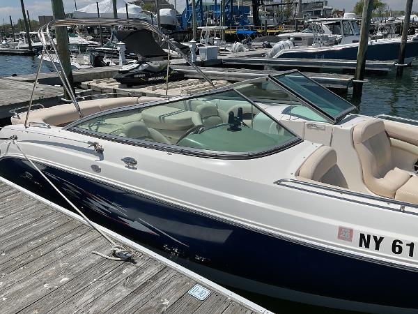 2006 Chaparral 256 SSi boat docked at a marina, featuring sleek design and comfortable seating.