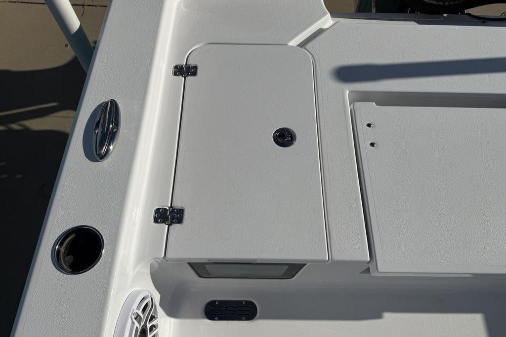 2026 Sportsman Masters 247OE Bay Boat deck with storage compartment and speaker.