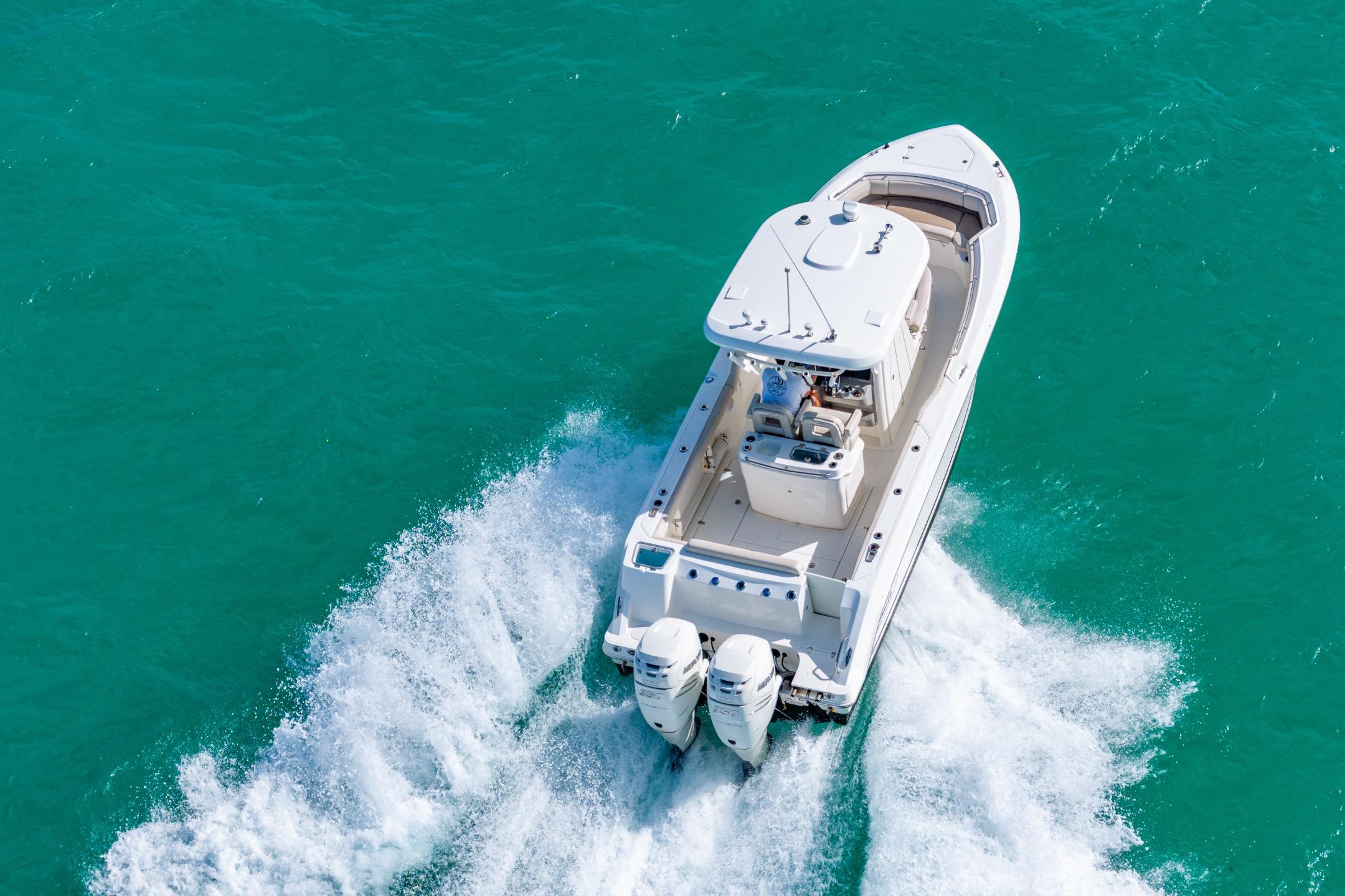 2016 Boston Whaler 280 Outrage cruising on turquoise water, aerial view.