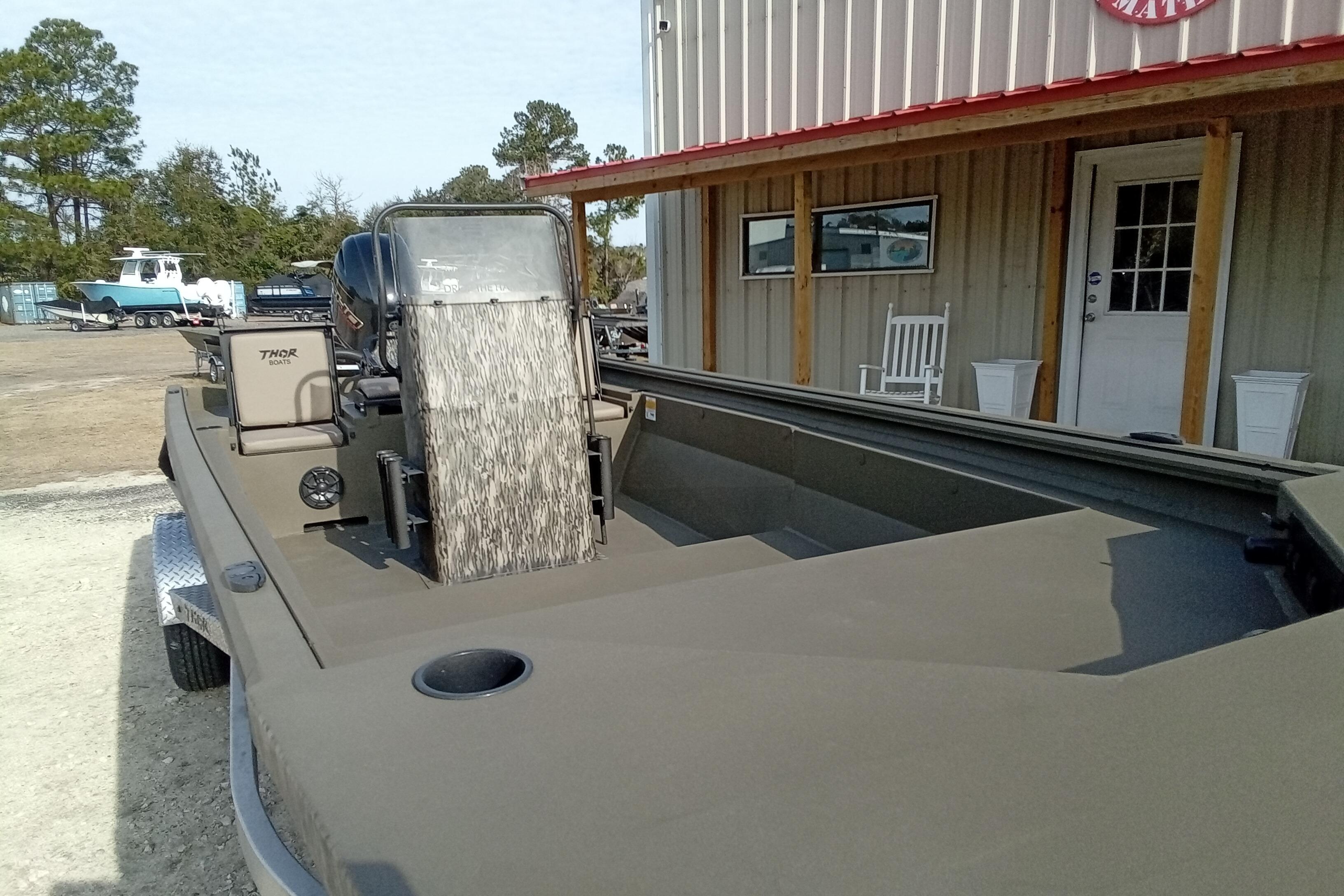 2026 Thor 1900 Low Country Elite boat parked outside a building.