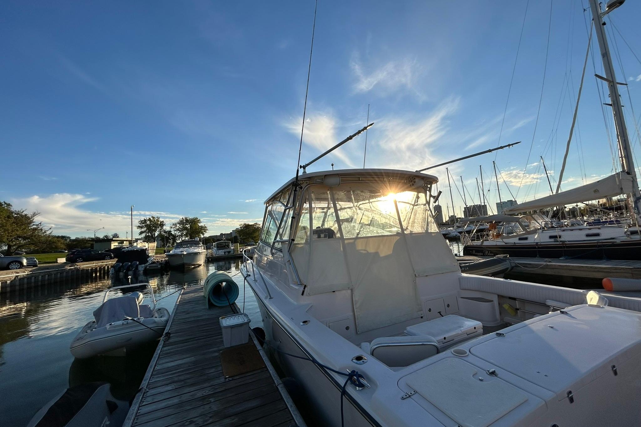 2007 Grady-White Express 360 docked at marina during sunset.