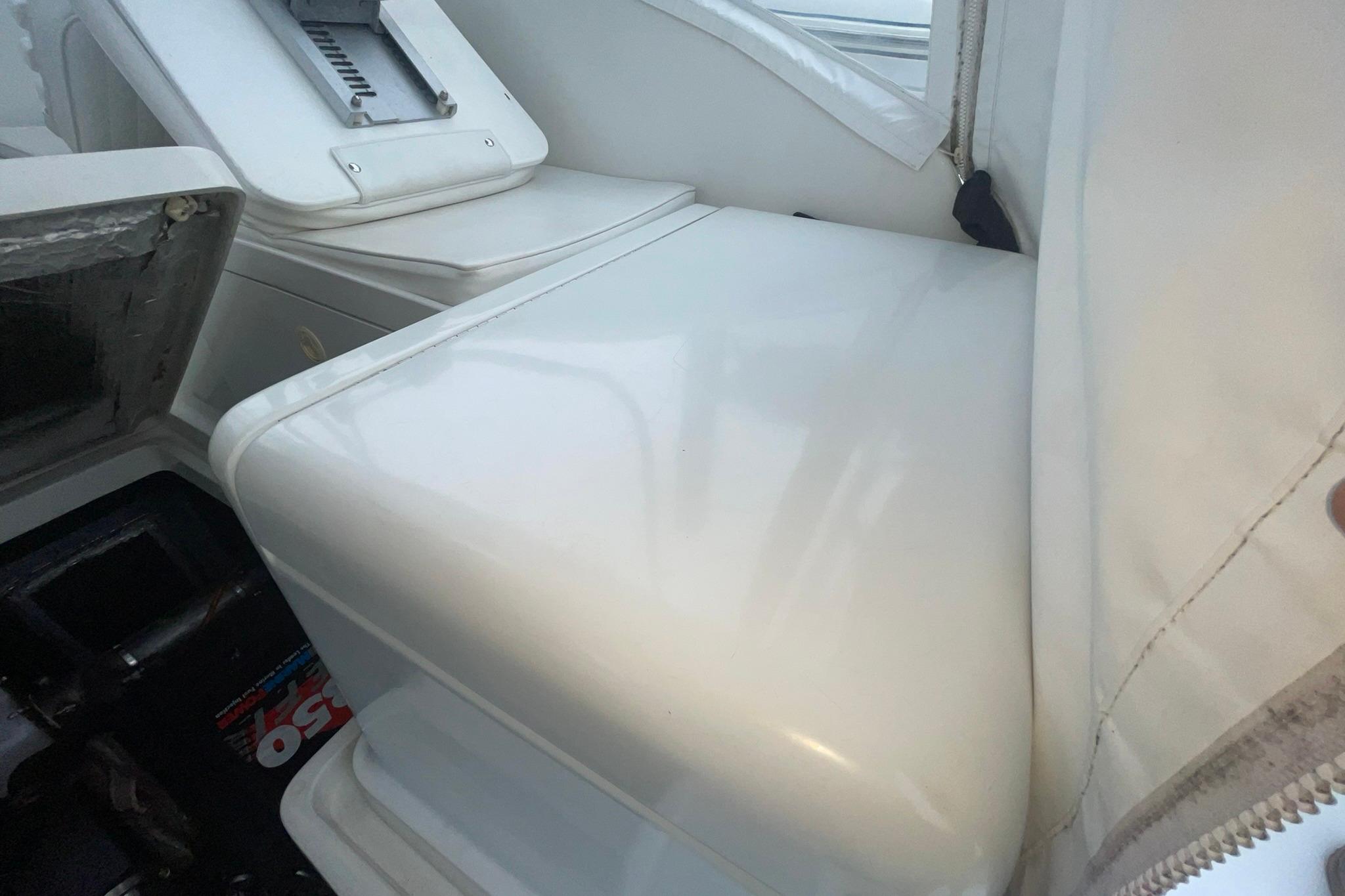 Interior view of a 1996 Luhrs Tournament 290 Open boat, showcasing seating and storage.
