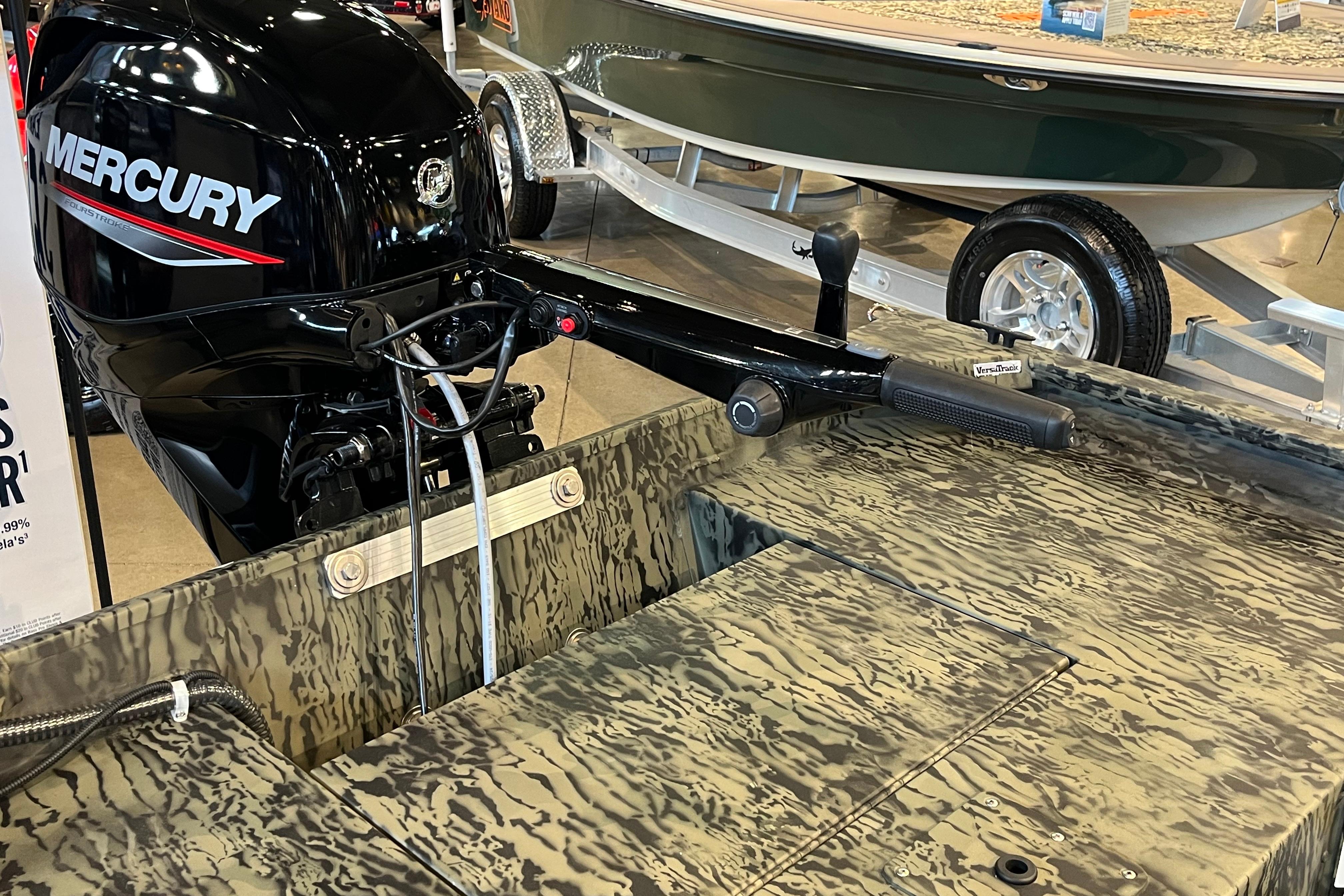2026 Tracker Grizzly 1654 T Sportsman boat with Mercury outboard motor, camo design.