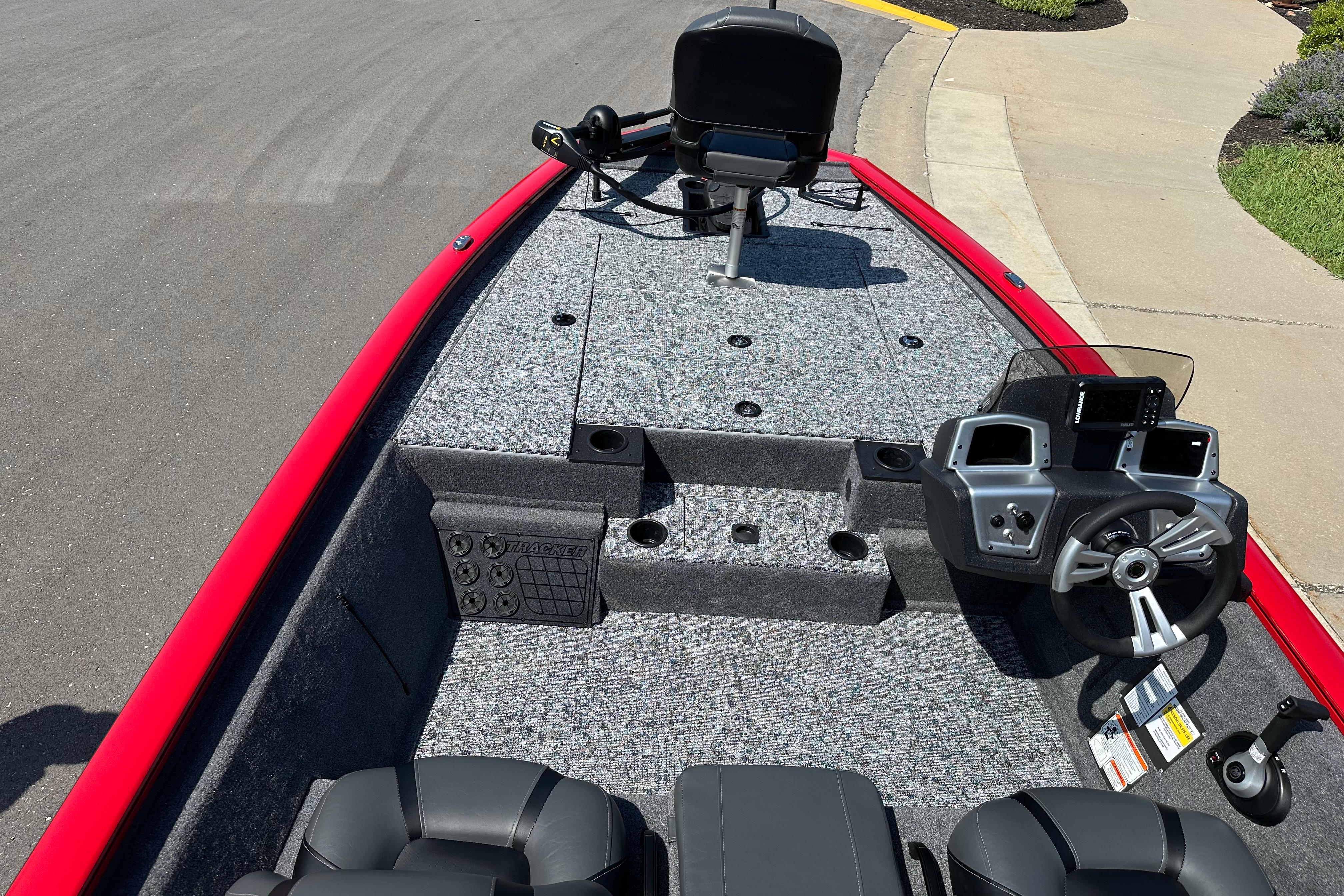 2026 Tracker Pro Team 195 boat interior with steering console and seating, featuring a red exterior.