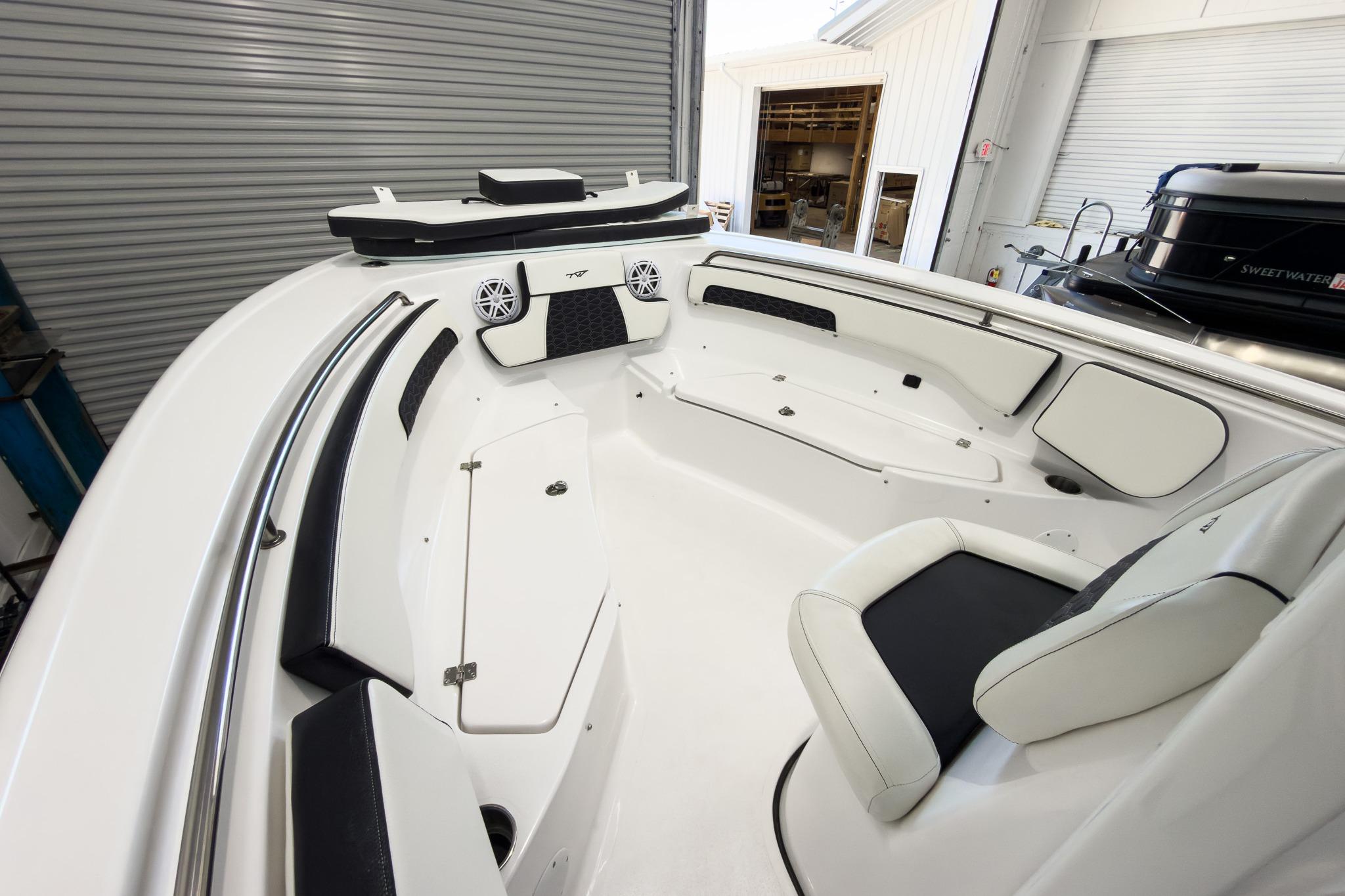 The image shows the cockpit of a Tidewater 220 LXF boat with white and black seating.