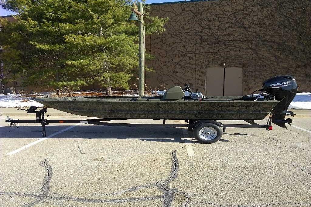 2026 Tracker Grizzly 1648 SC boat on trailer in parking lot.