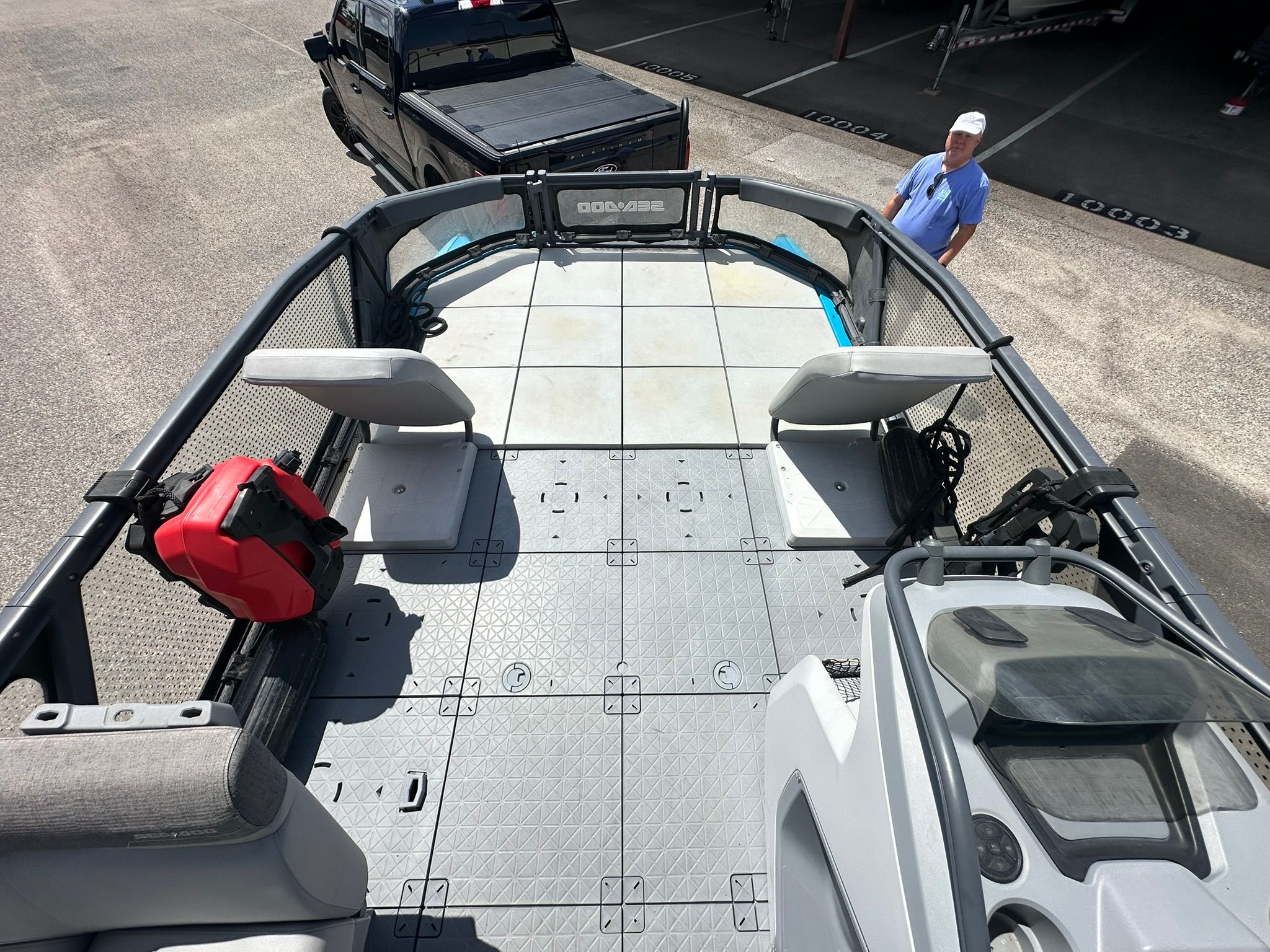 The image shows the deck of a 2023 Sea-Doo 21 SWITCH SPORT with seating and a helm console.