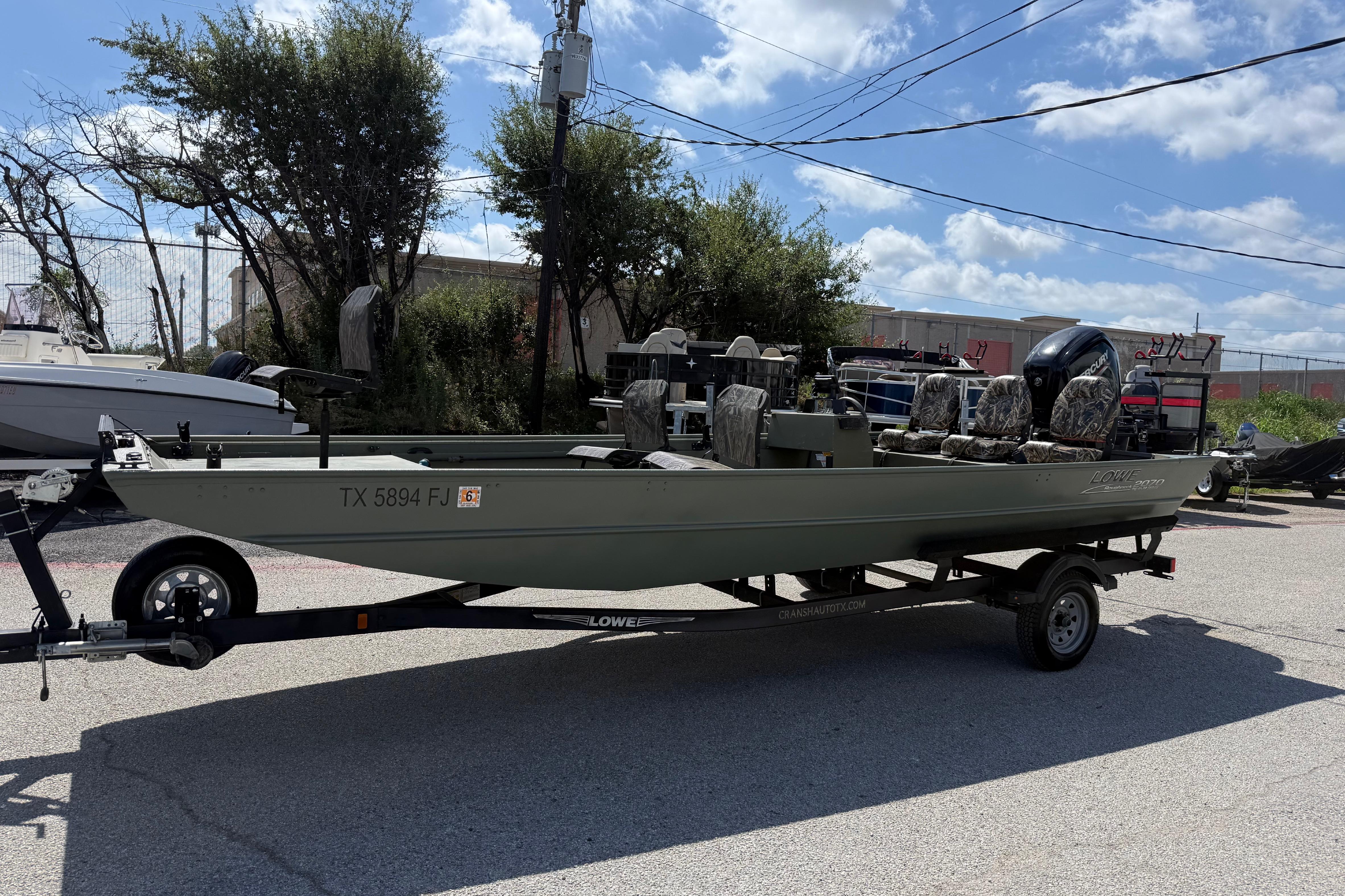 A 2020 Lowe Roughneck 2070 Big River boat on a trailer, ready for use.