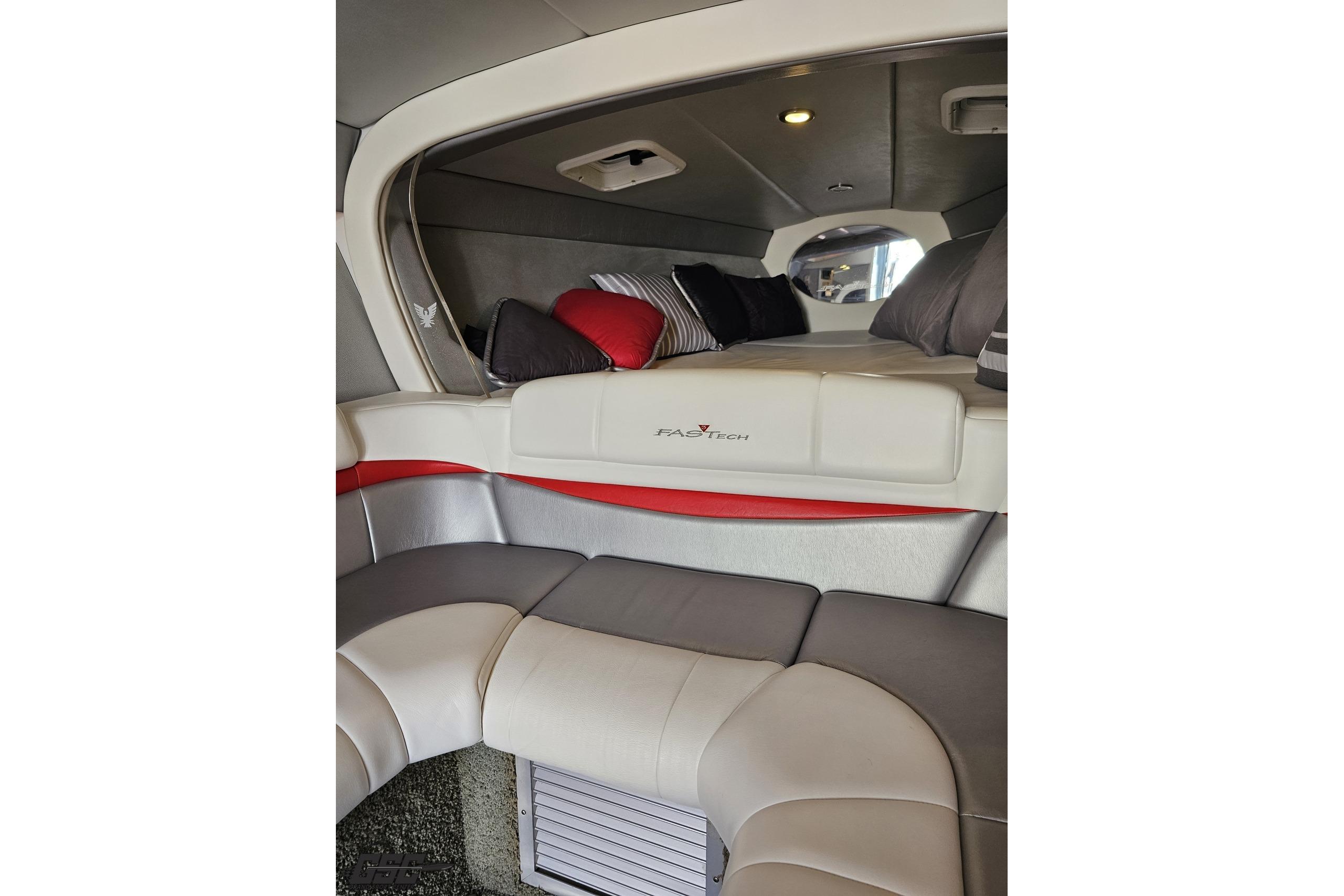 Interior of a 2012 Formula 353 FASTech boat with plush seating and cozy cabin.