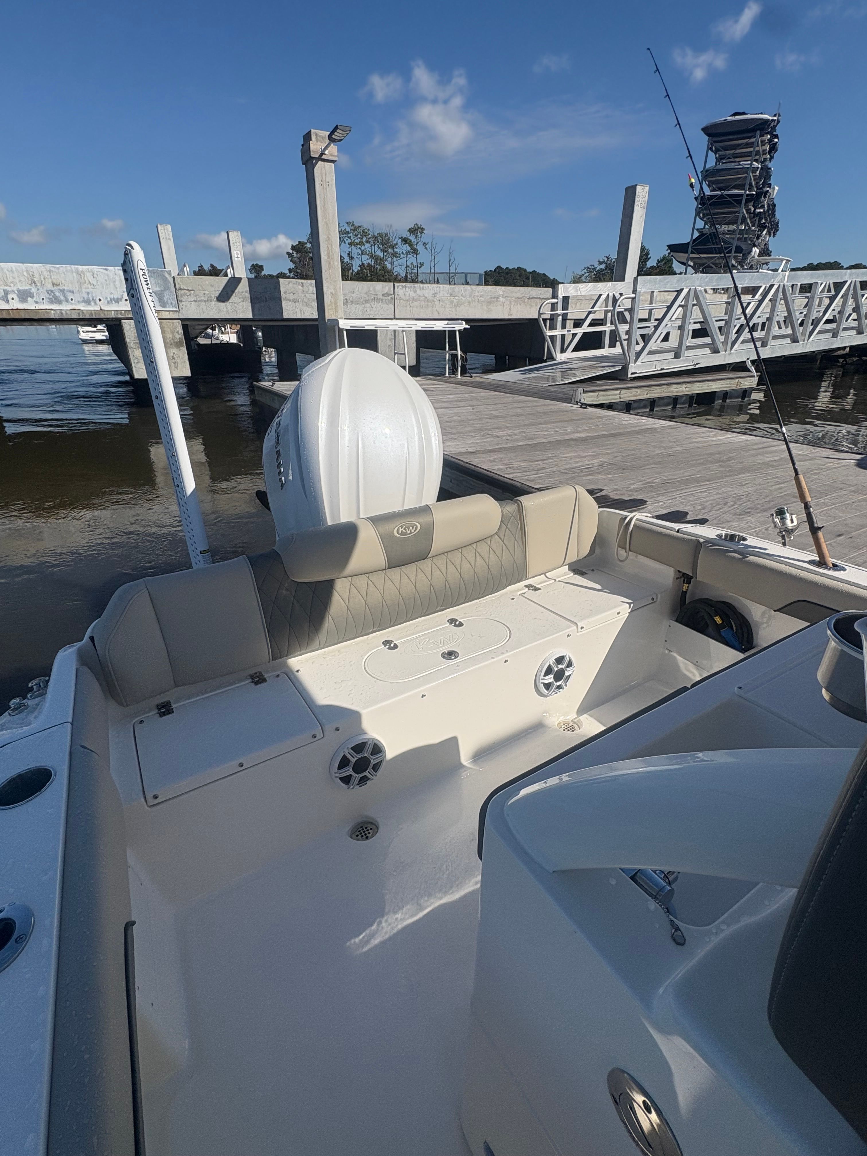 The image shows the stern of a Key West 239 FSR boat at a dock.