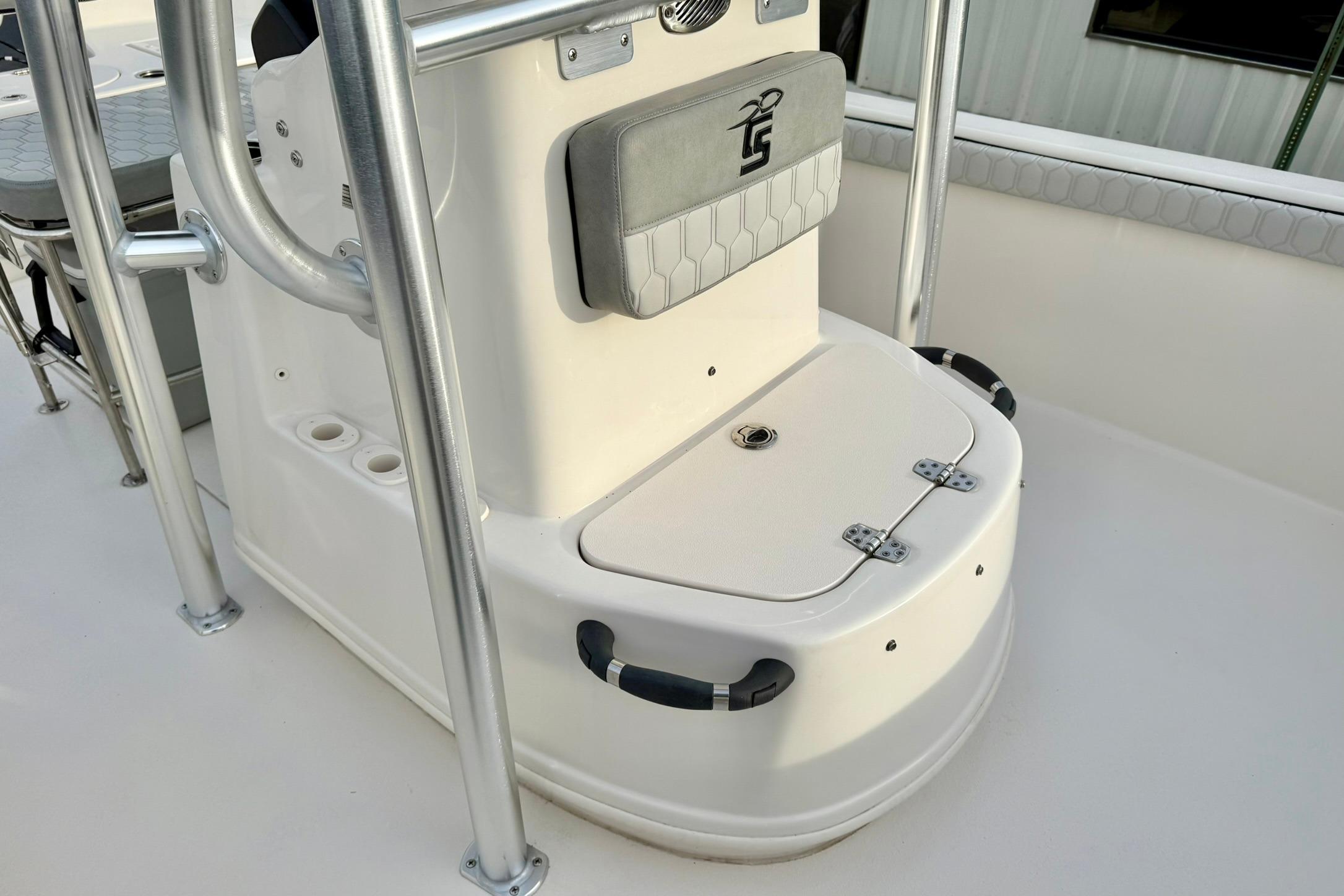 2025 Carolina Skiff 21 LS boat console with storage compartment and stainless steel railings.