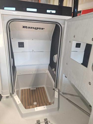 2025 Ranger 2660 Bay boat interior with open cabin door and wood flooring.