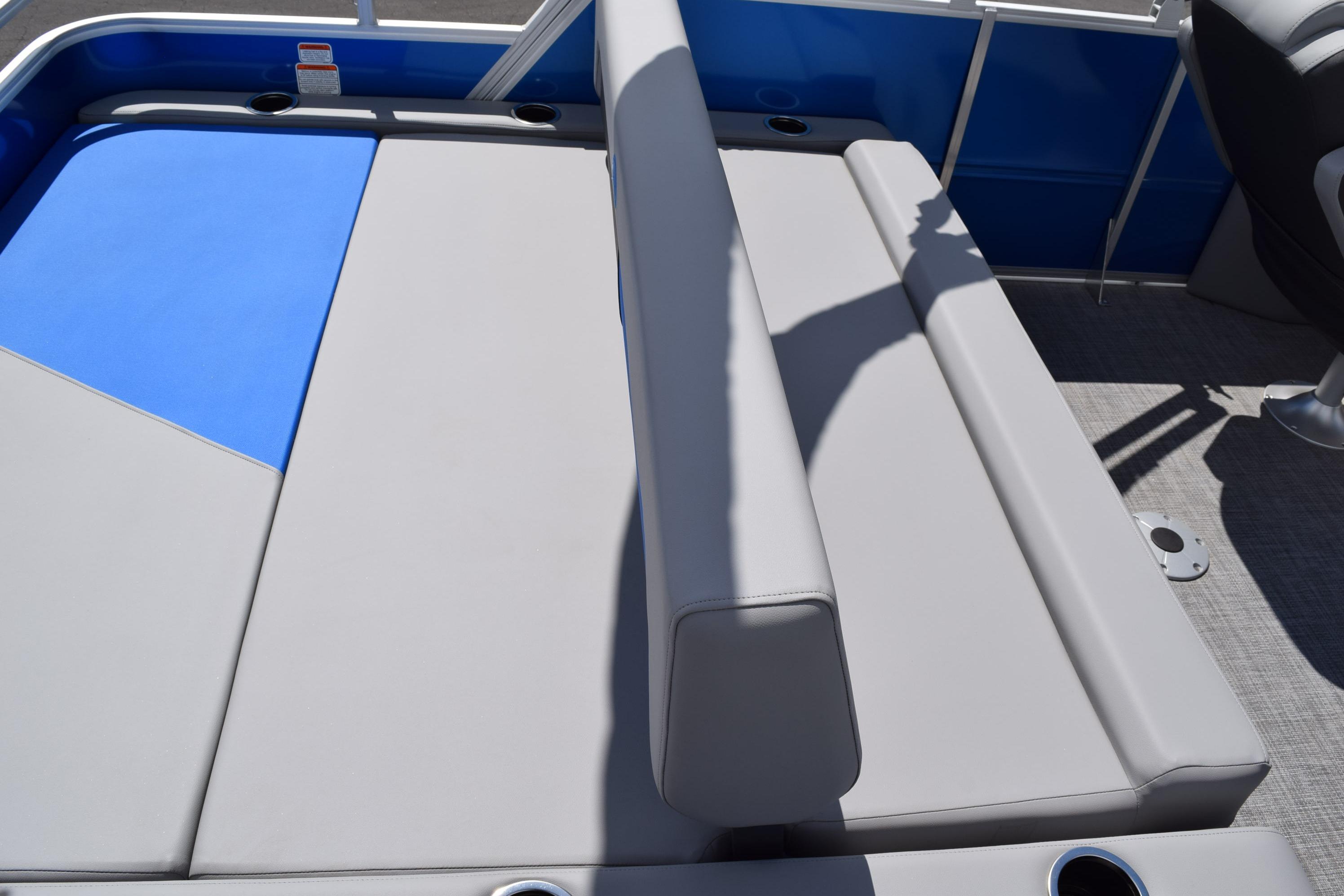 2026 Sun Tracker Party Barge 22 RF XP3 interior seating with gray upholstery and blue accents.