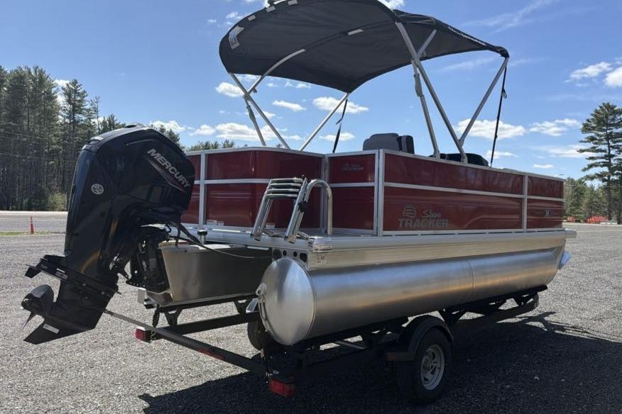 2026 Sun Tracker Party Barge 18 DLX pontoon boat with canopy and outboard motor.
