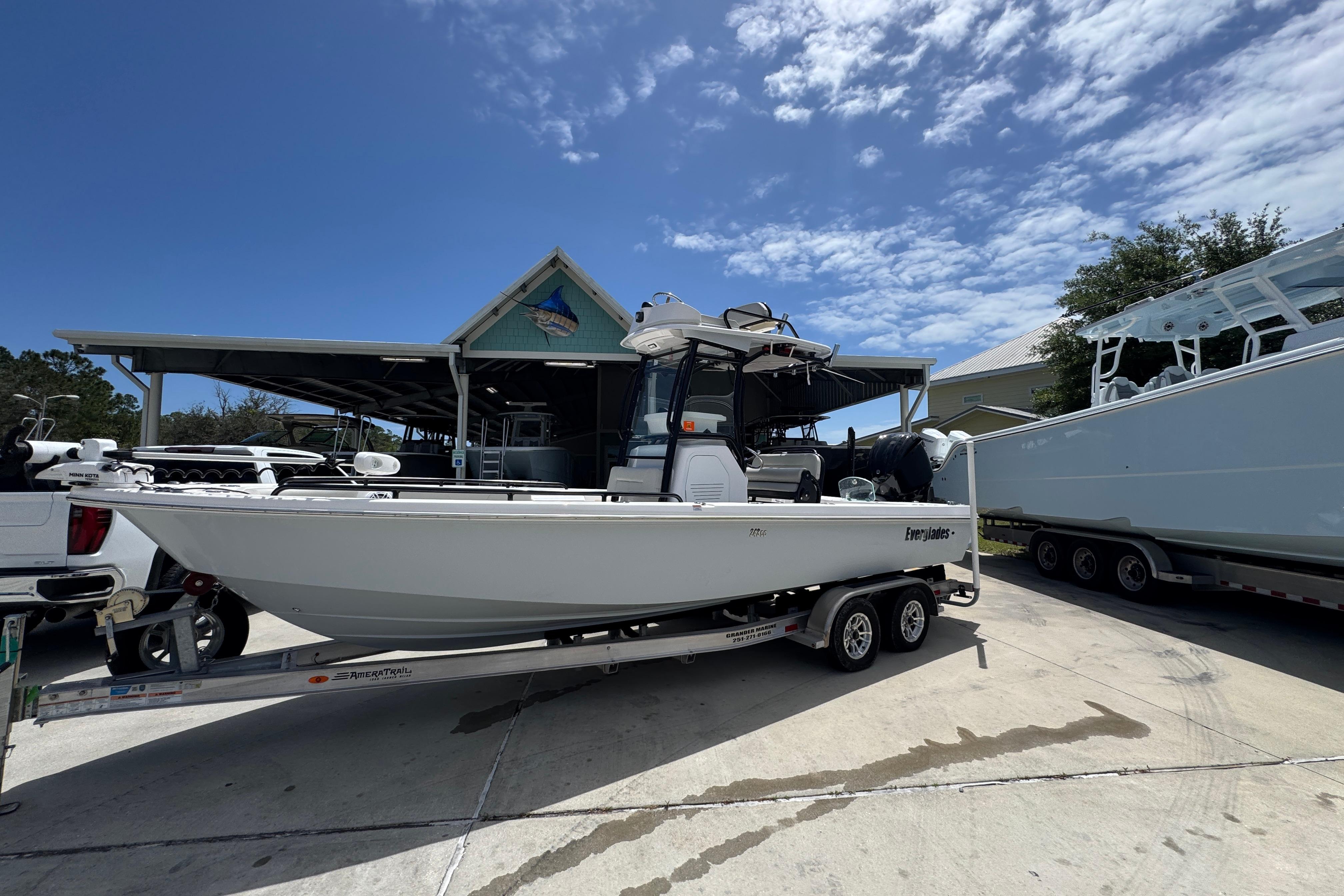 2022 Everglades 243 Center Console boat on trailer under clear blue sky.
