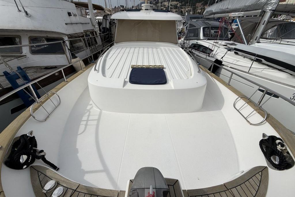 Deck view of 2012 Sasga Yachts Menorquin 42, docked among other boats.