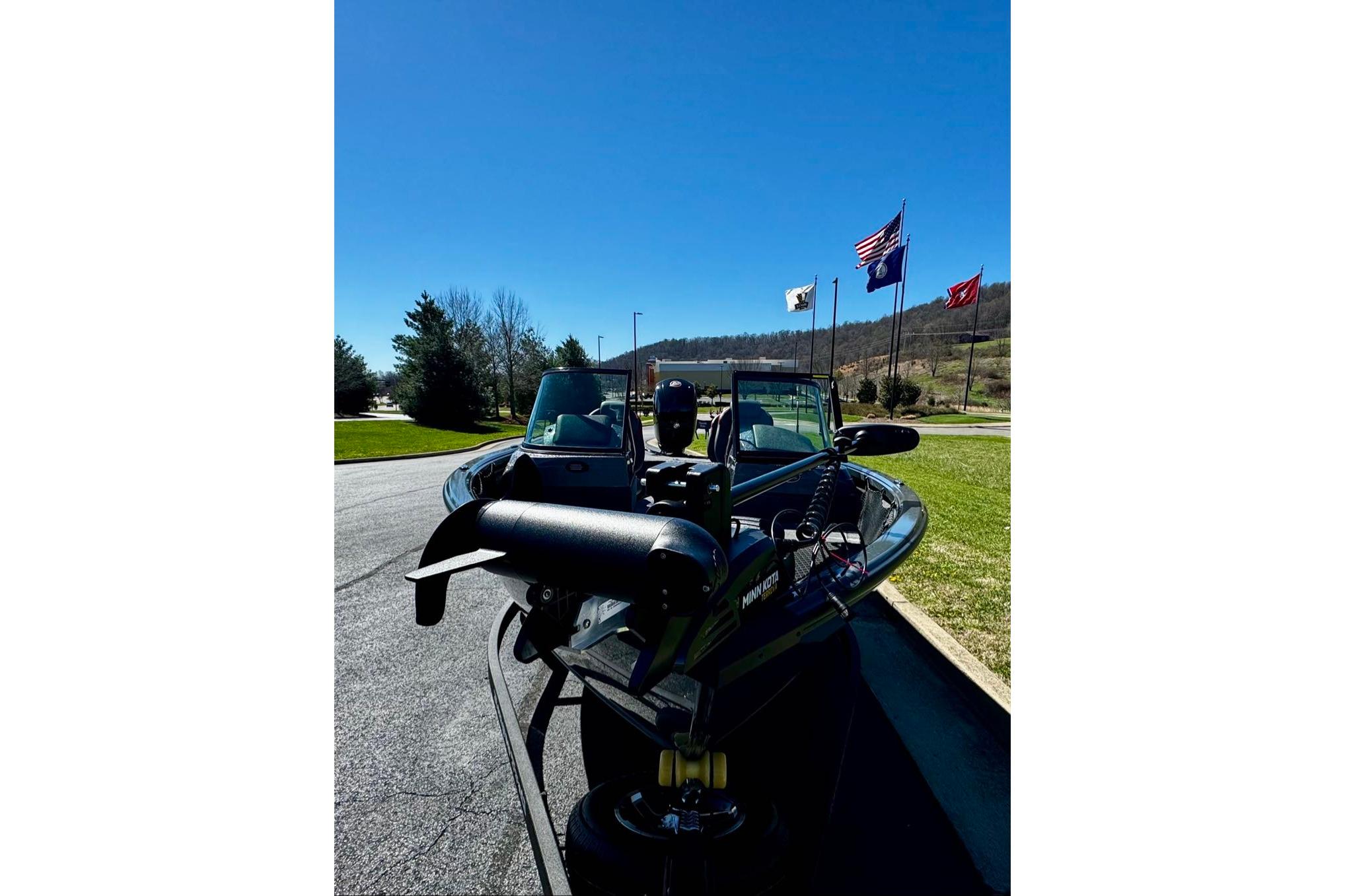 2026 Ranger VS1882SC Reata boat on trailer, flags in background, sunny day.