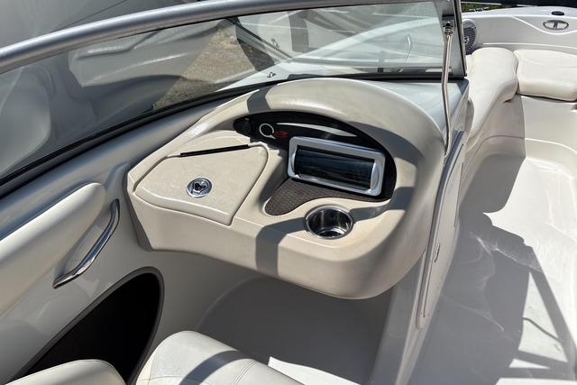 Interior view of a 2012 Tahoe Q8 SSi boat dashboard with steering and controls.