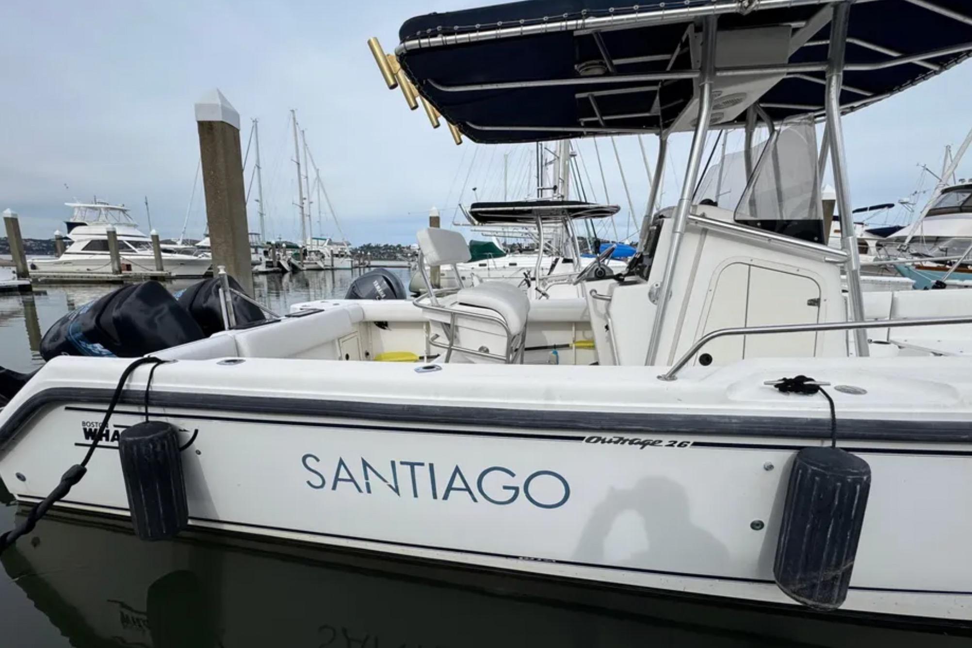 2001 Boston Whaler 26 Outrage boat named "Santiago" docked in a marina.
