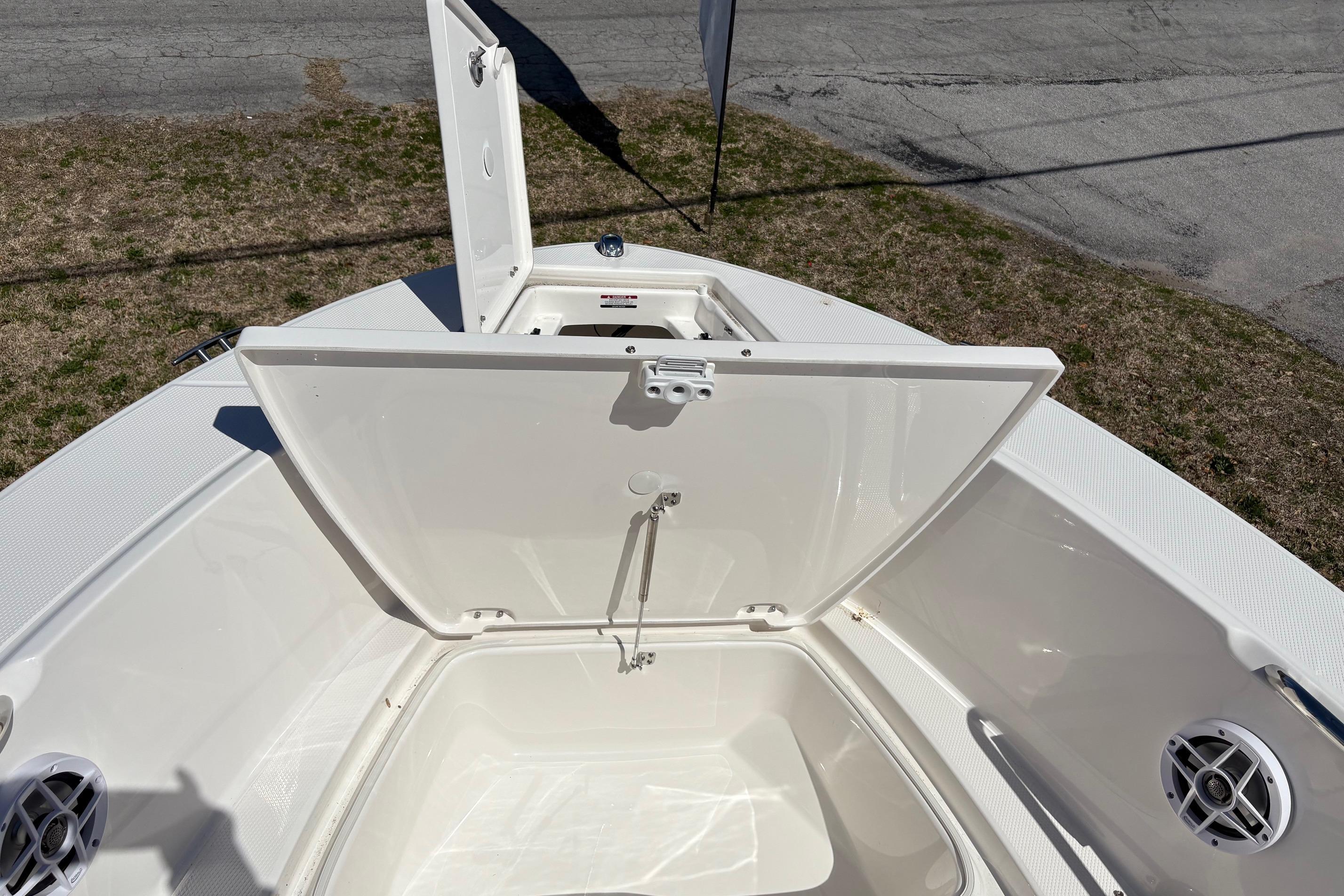2026 Robalo R180 Center Console boat with open storage compartment.
