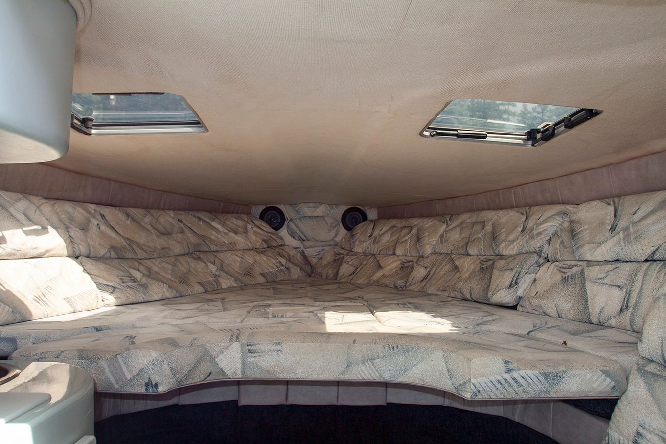 Interior of a 1995 Mirage Trovare 275 boat with cushioned seating.