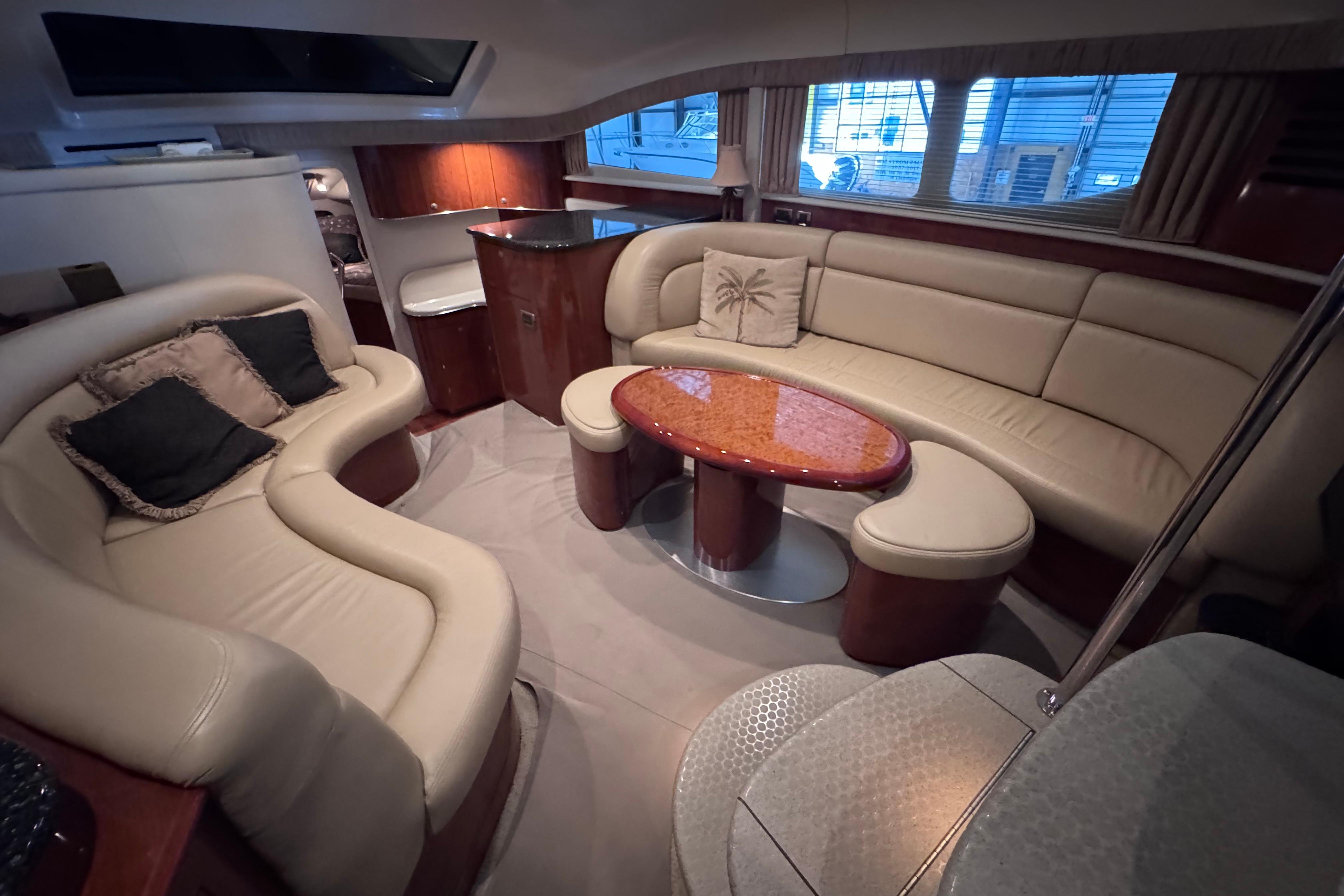 Luxurious interior of a 2004 Sea Ray 390 Motor Yacht with elegant seating and wooden accents.