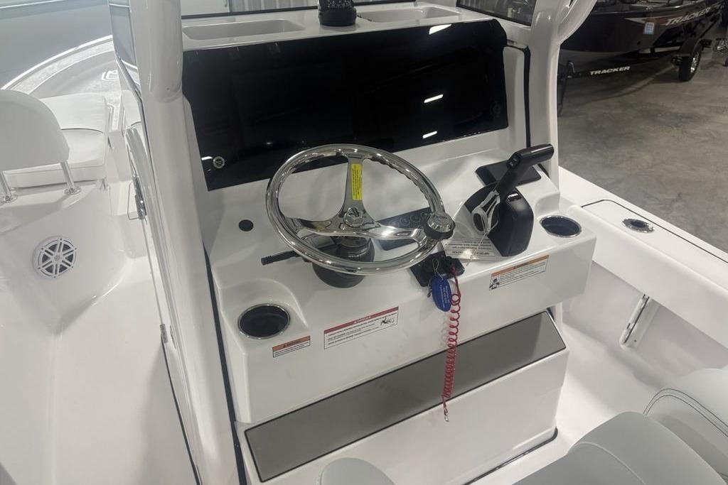 2026 Sportsman Masters 227 boat console with steering wheel and controls.