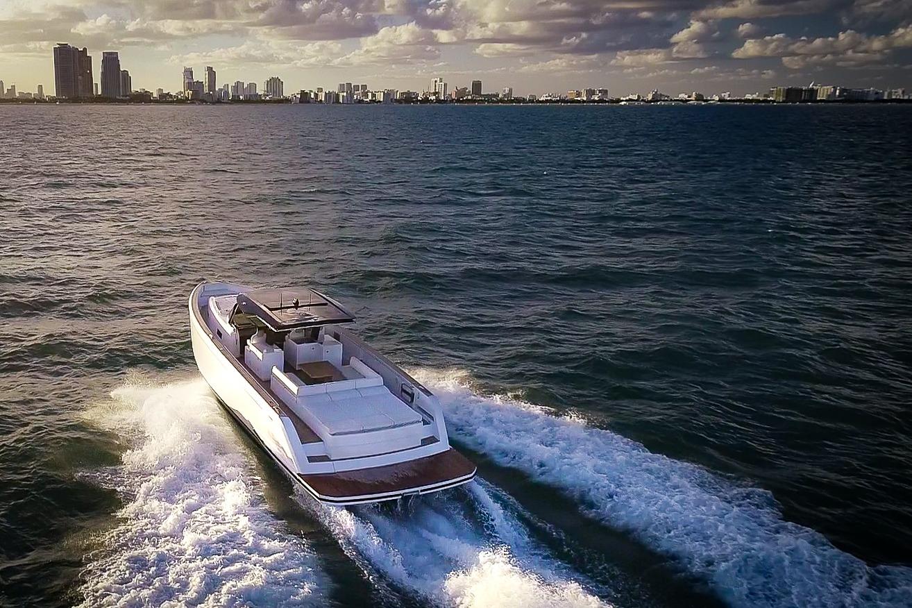 2025 Pardo Yachts 50 cruising on ocean with city skyline in background.