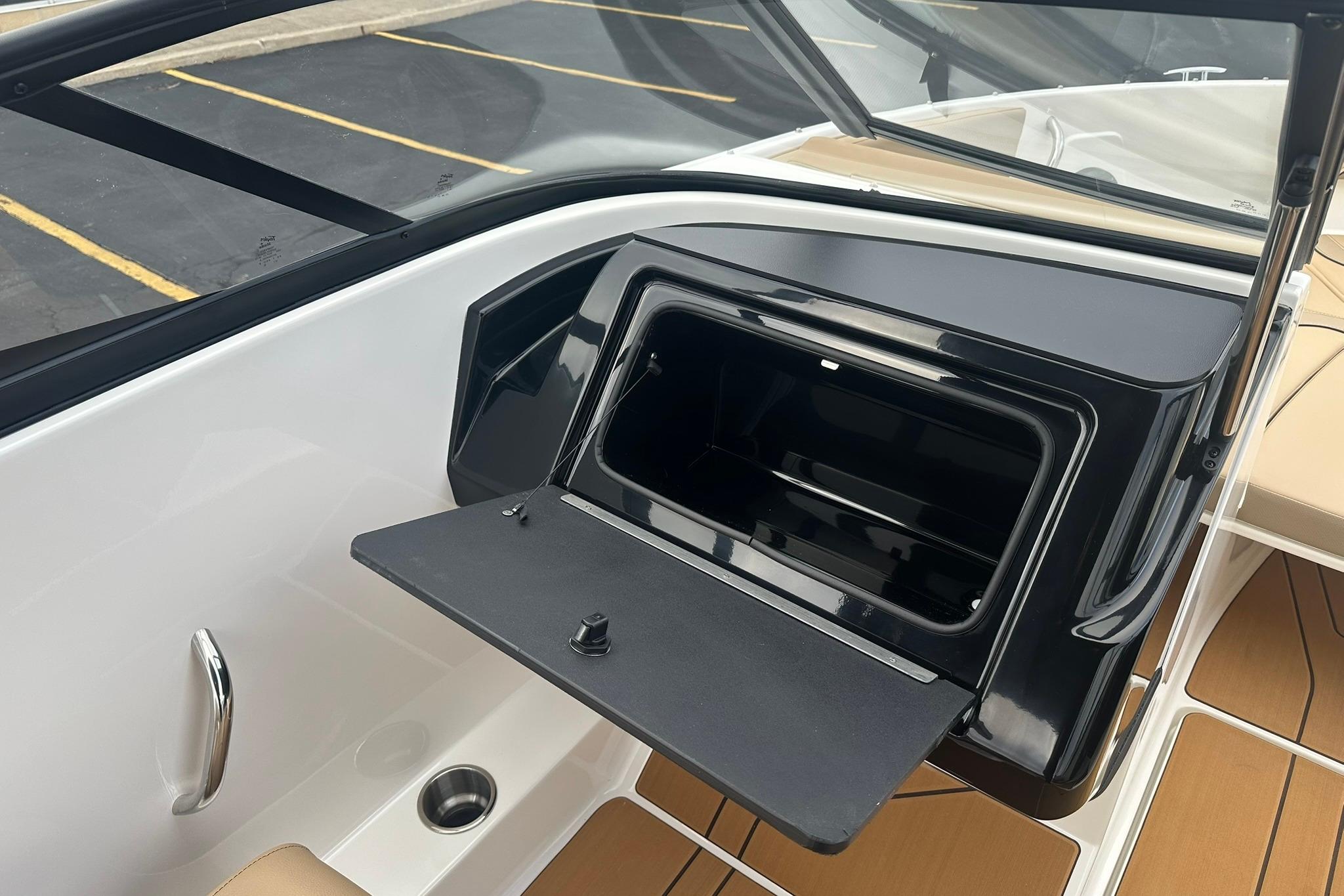 2026 Bayliner V20 boat interior with open storage compartment and sleek design.