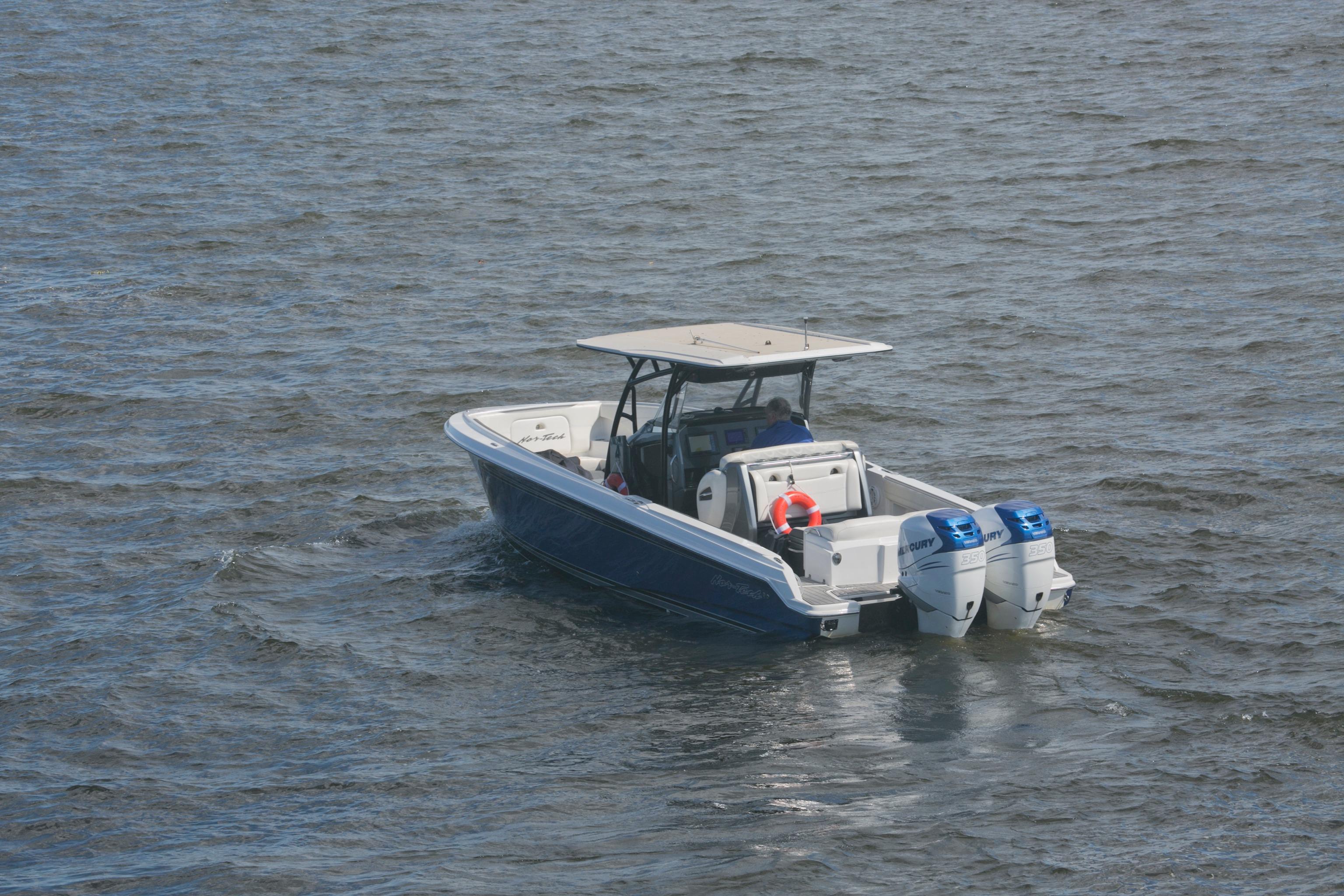 2018 Nor-Tech 340 Sport Center Console boat on open water with dual engines.