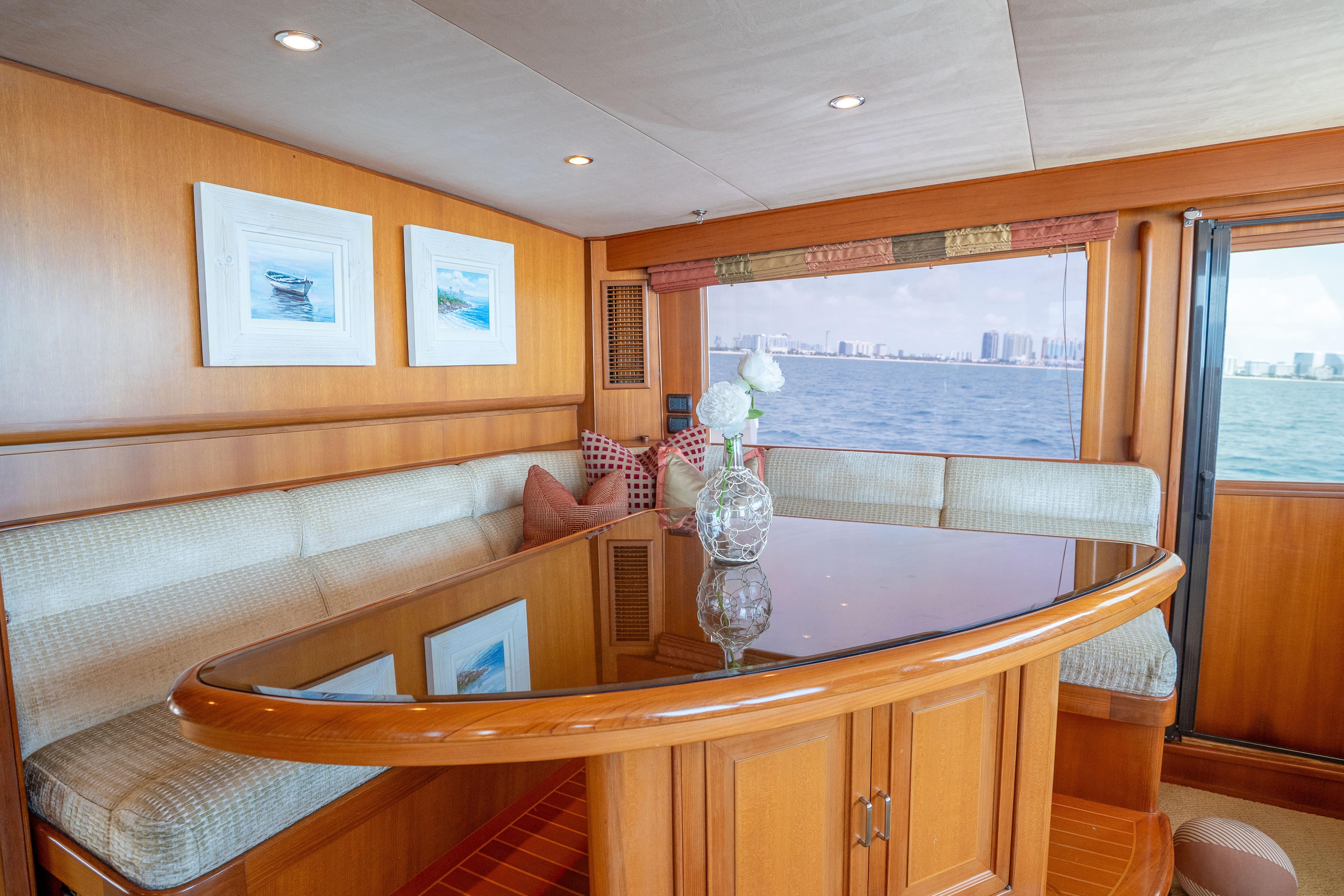 Luxurious 2006 Fleming 75 yacht interior with elegant dining area and ocean view.