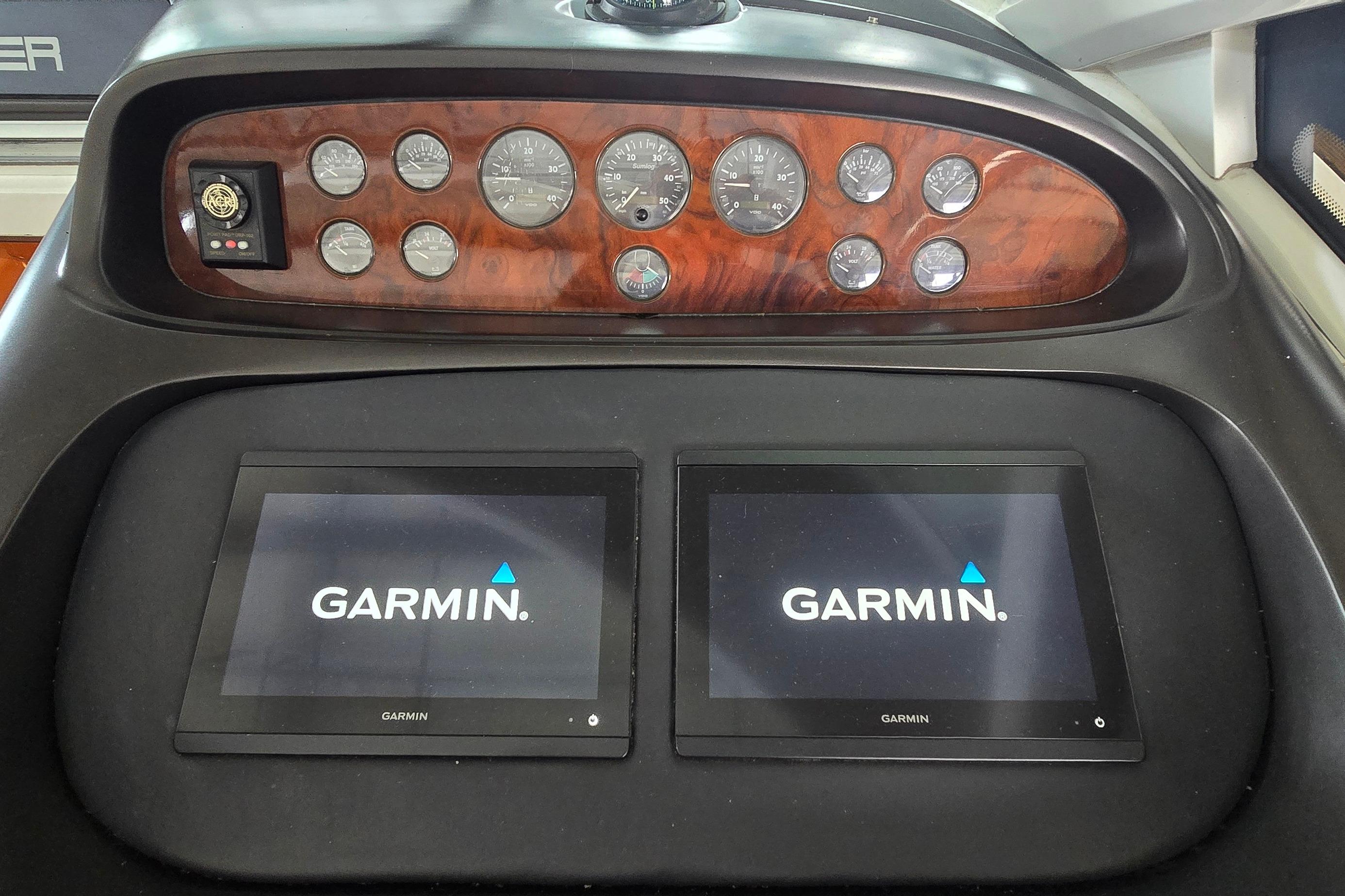 Dashboard of 2004 Sunseeker Camargue 50 with Garmin navigation displays and analog gauges.